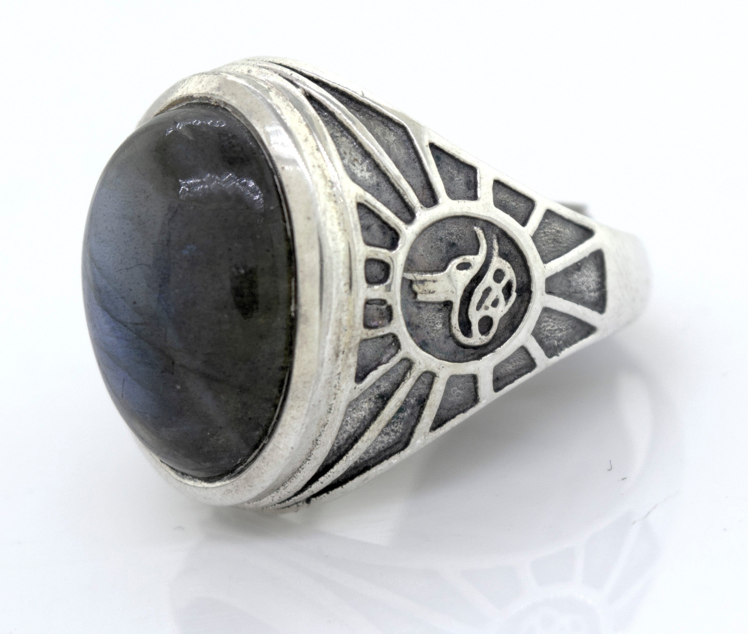 A mens sterling silver ring with a Labradorite Oval Signet Ring With Wolf Symbol.