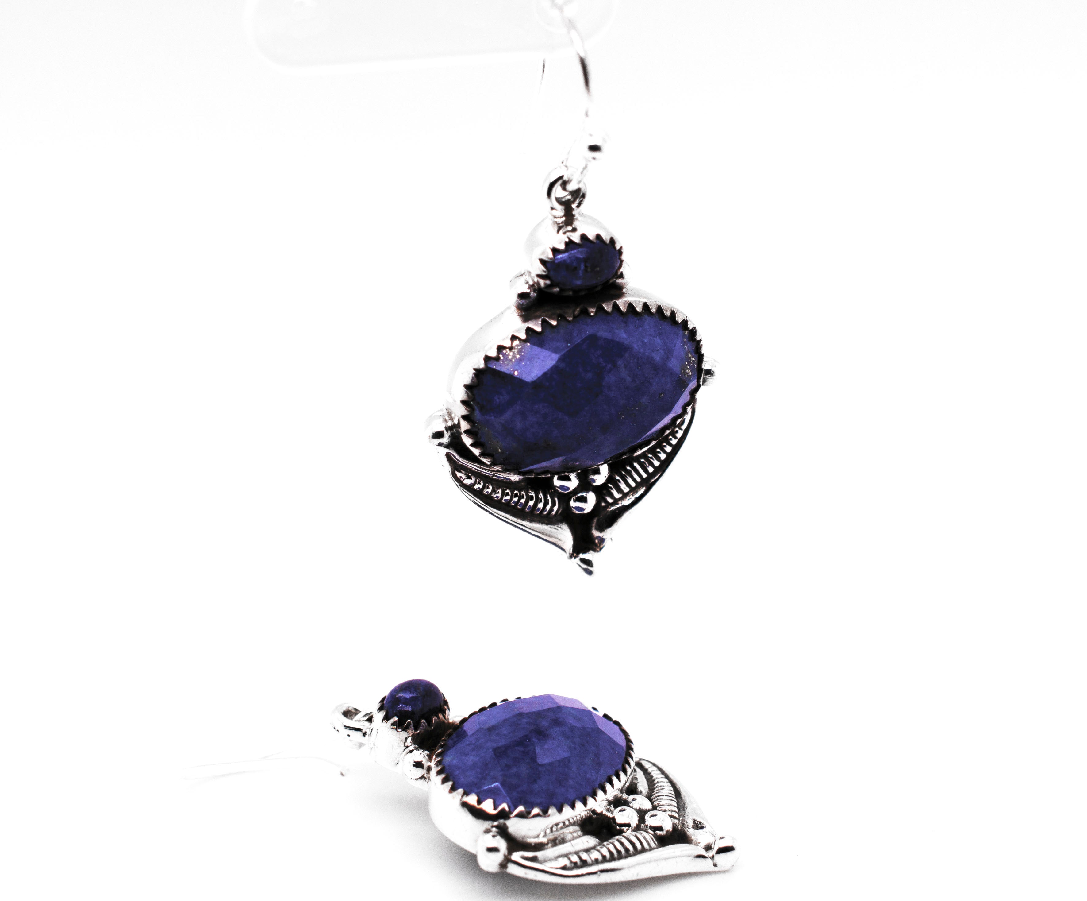 A pair of Super Silver Spectacular Faceted Gemstone Earrings with blue stones.