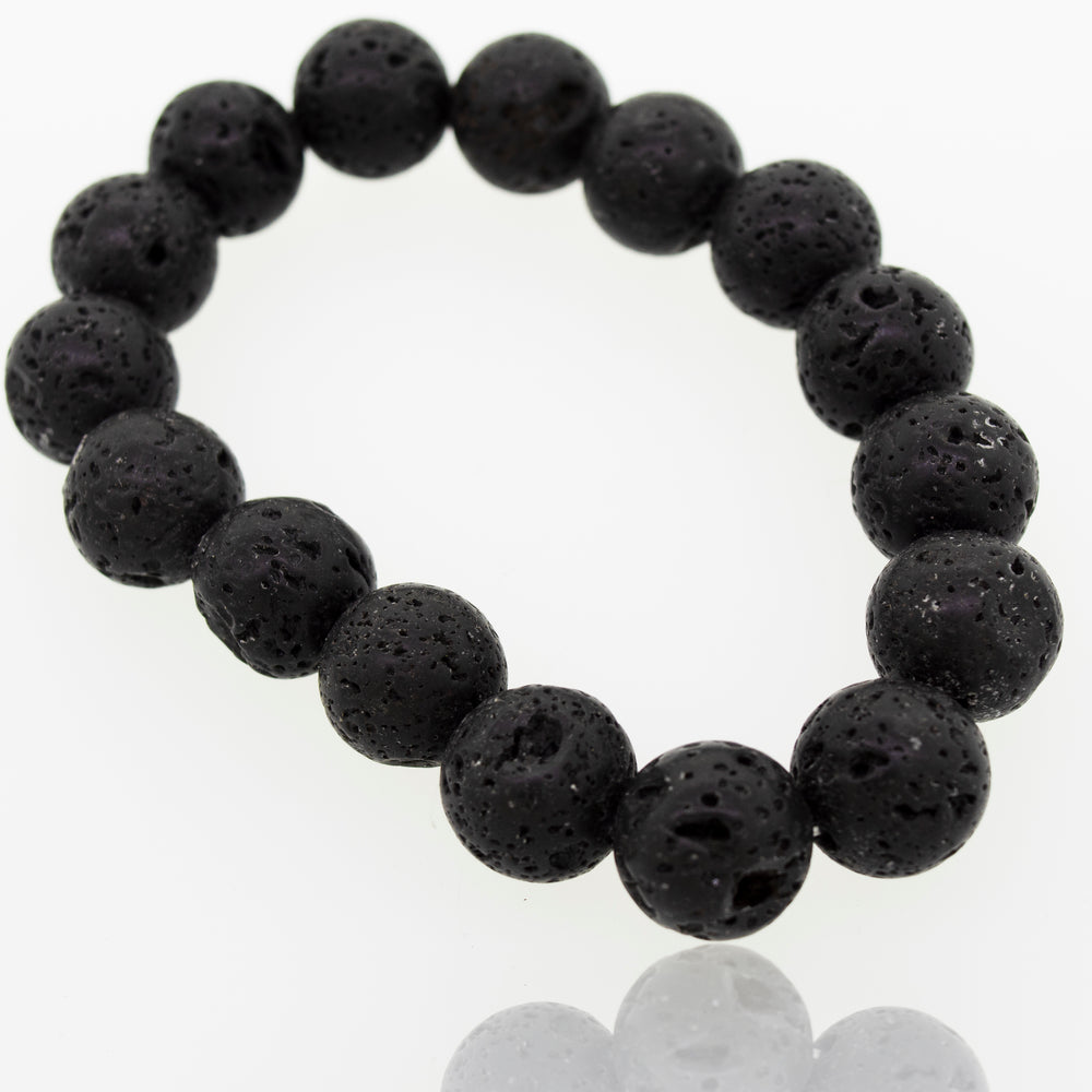 
                  
                    A Super Silver Essential Oil Bracelet with Lava Rock Beads, a grounding stone, on a white surface.
                  
                