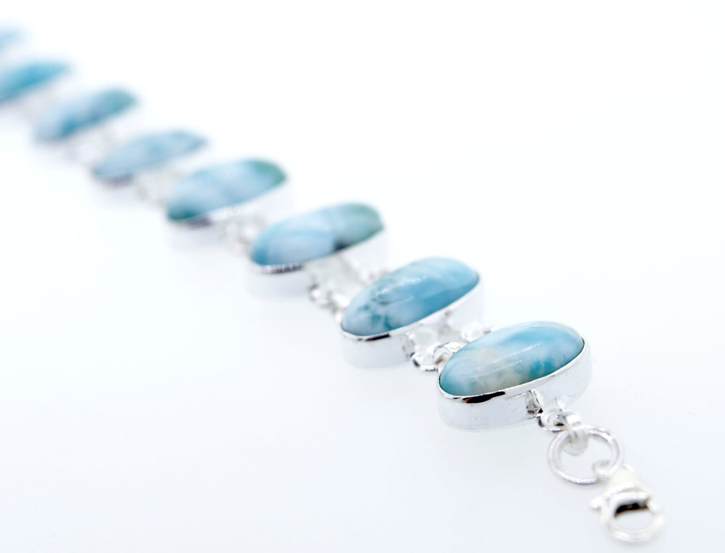 A Beautiful Oval Larimar Bracelet adorned with larimar stones, perfect for a beach outfit, from the Super Silver brand.