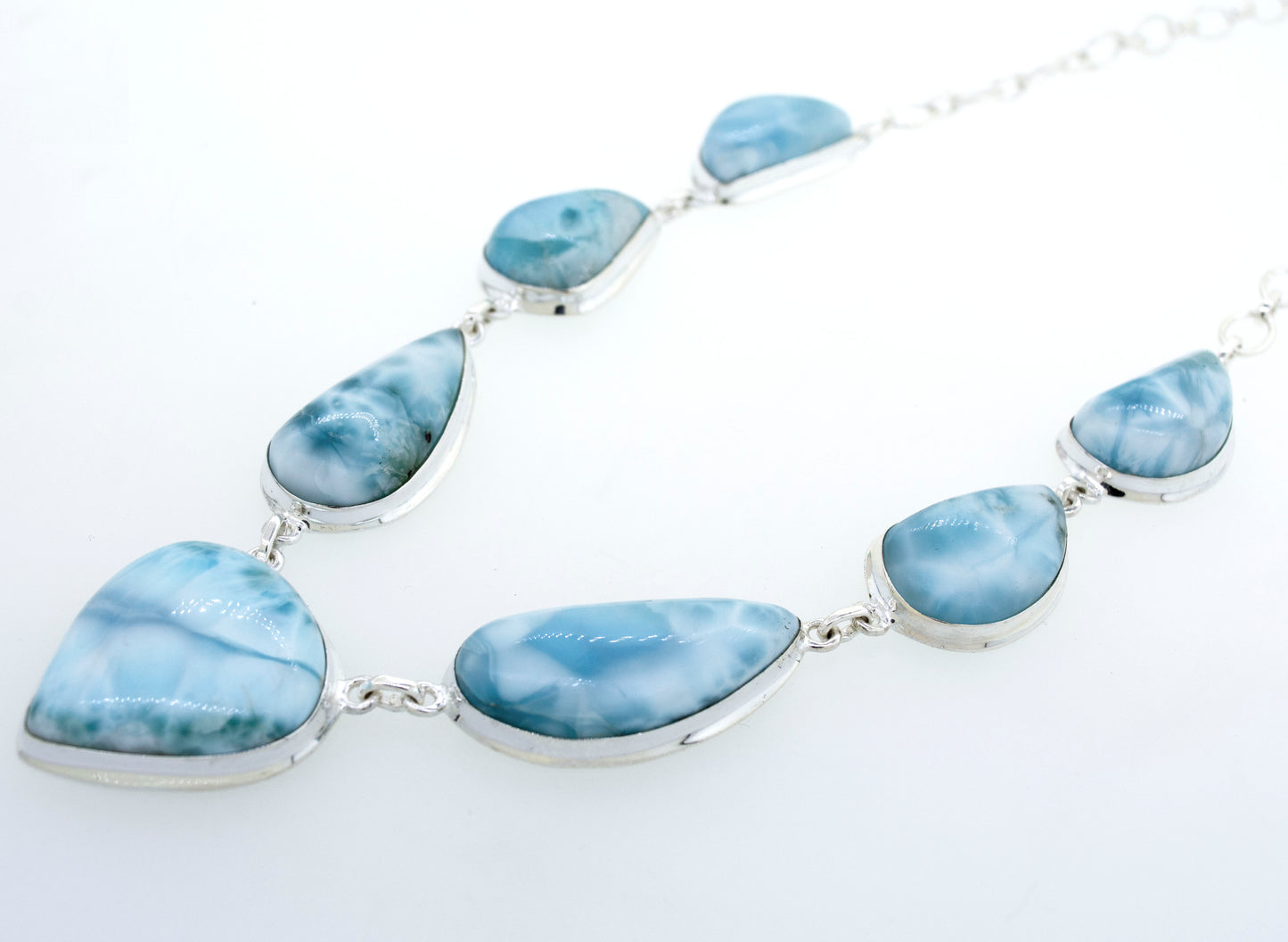 
                  
                    A beautiful Super Silver Larimar Necklace With Teardrop Shape Stones on a white surface.
                  
                