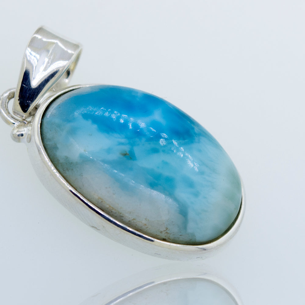 A gorgeous Super Silver Smaller Oval Larimar Pendant for everyday wear with a blue stone.