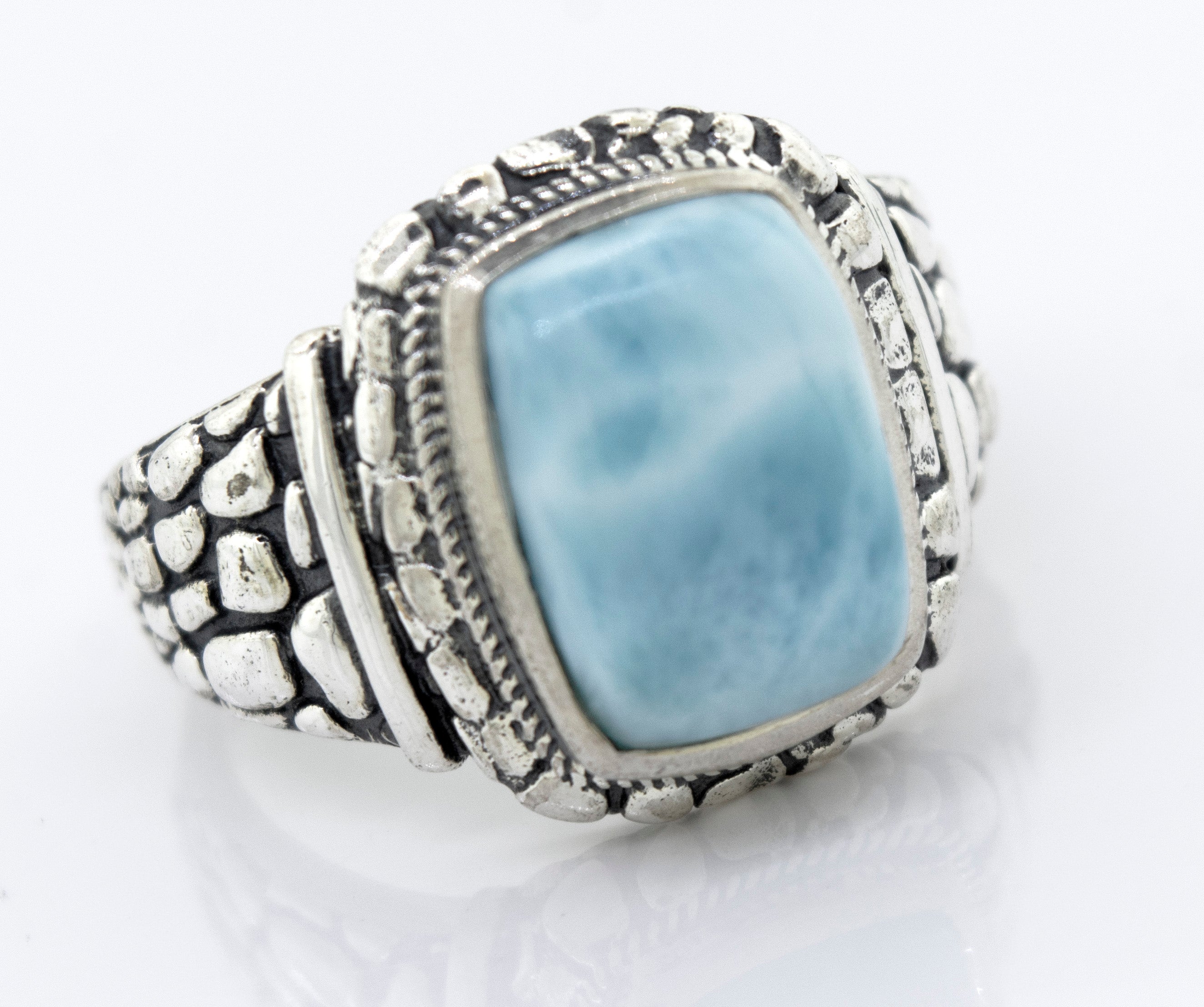 A Larimar signet ring with a large blue stone.