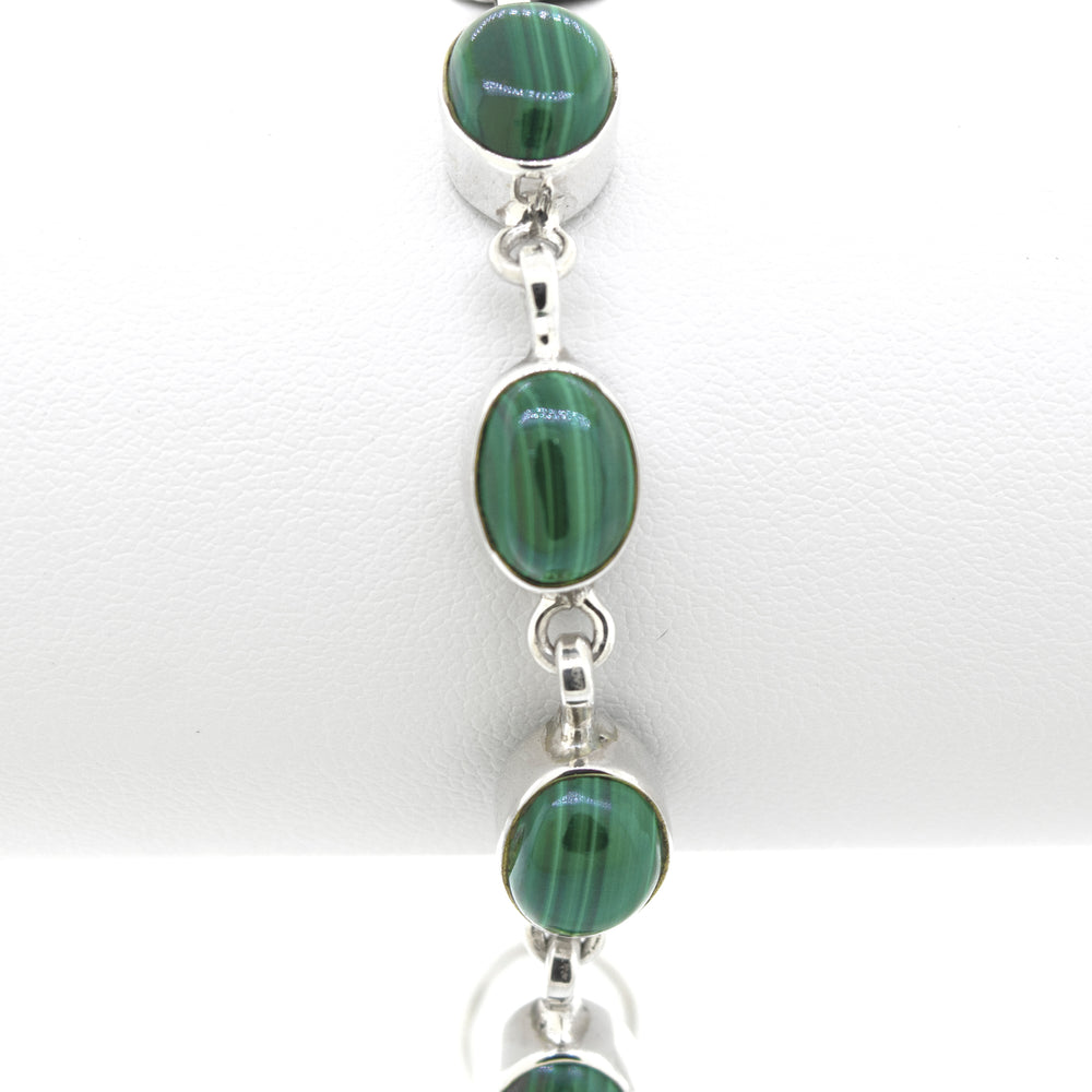 
                  
                    A Super Silver Simple Oval Gemstone Bracelet adorned with stunning green malachite stones.
                  
                