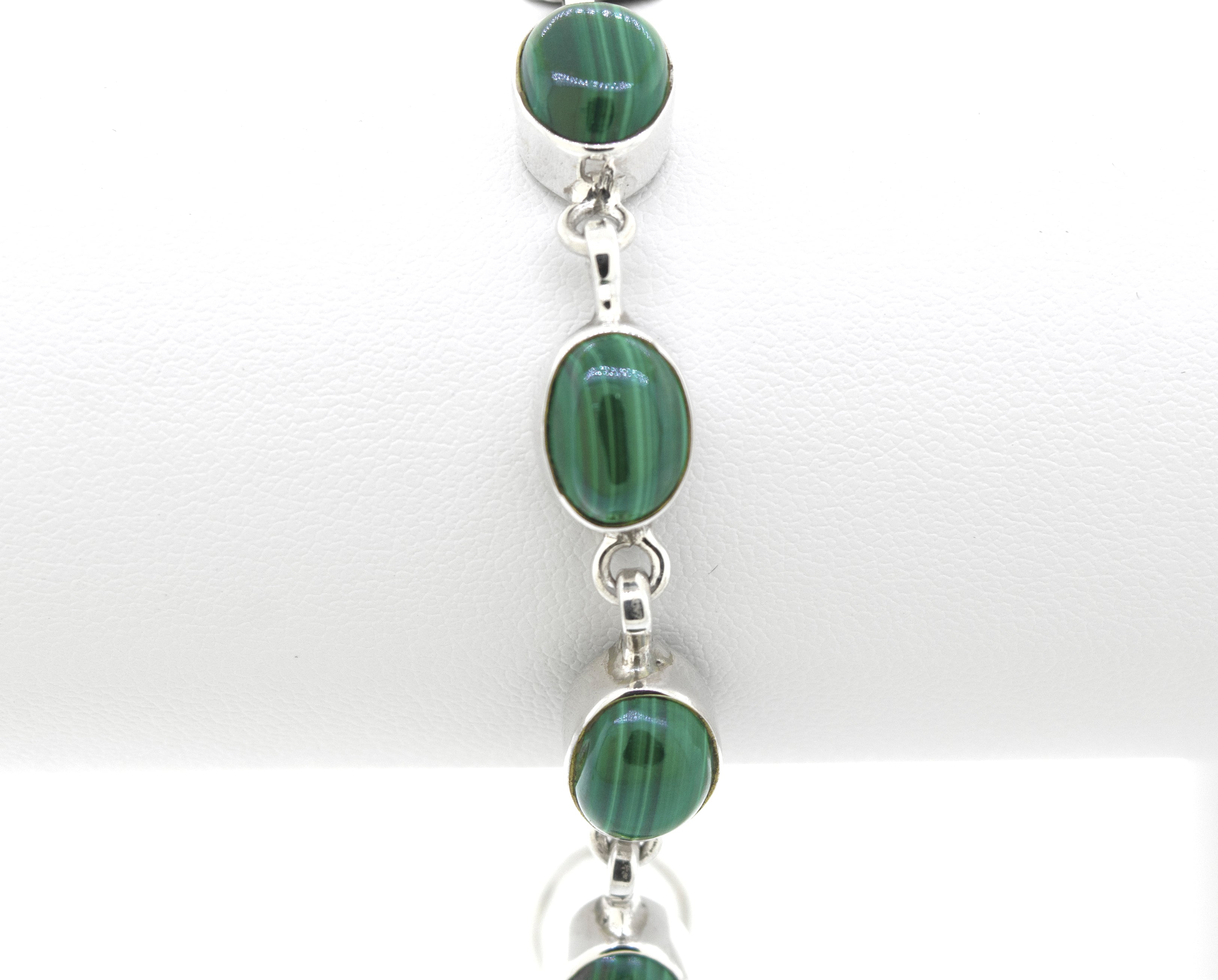 A Super Silver Simple Oval Gemstone Bracelet adorned with stunning green malachite stones.