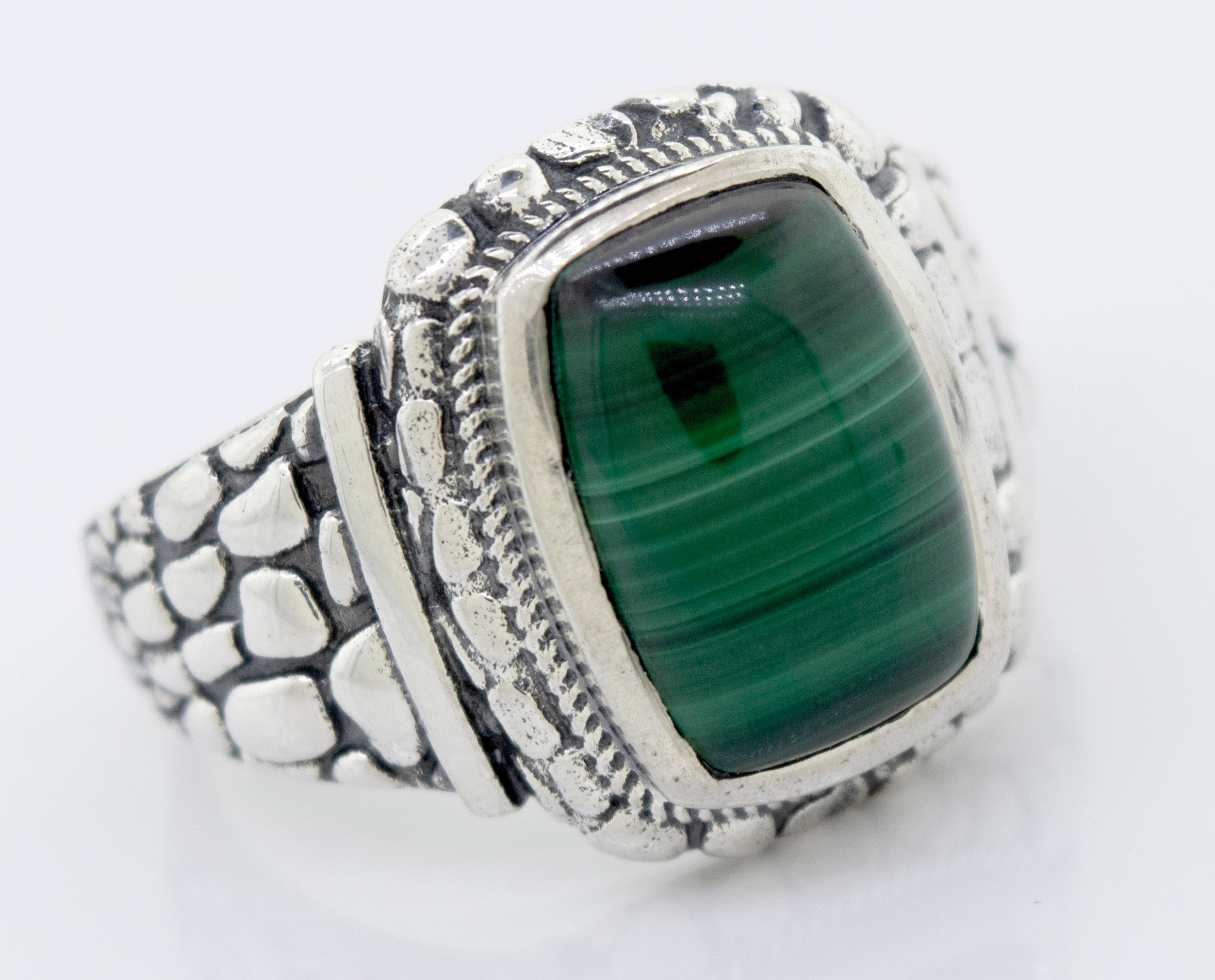A Malachite Signet Ring With Dragon Scale Pattern with a green stone.
