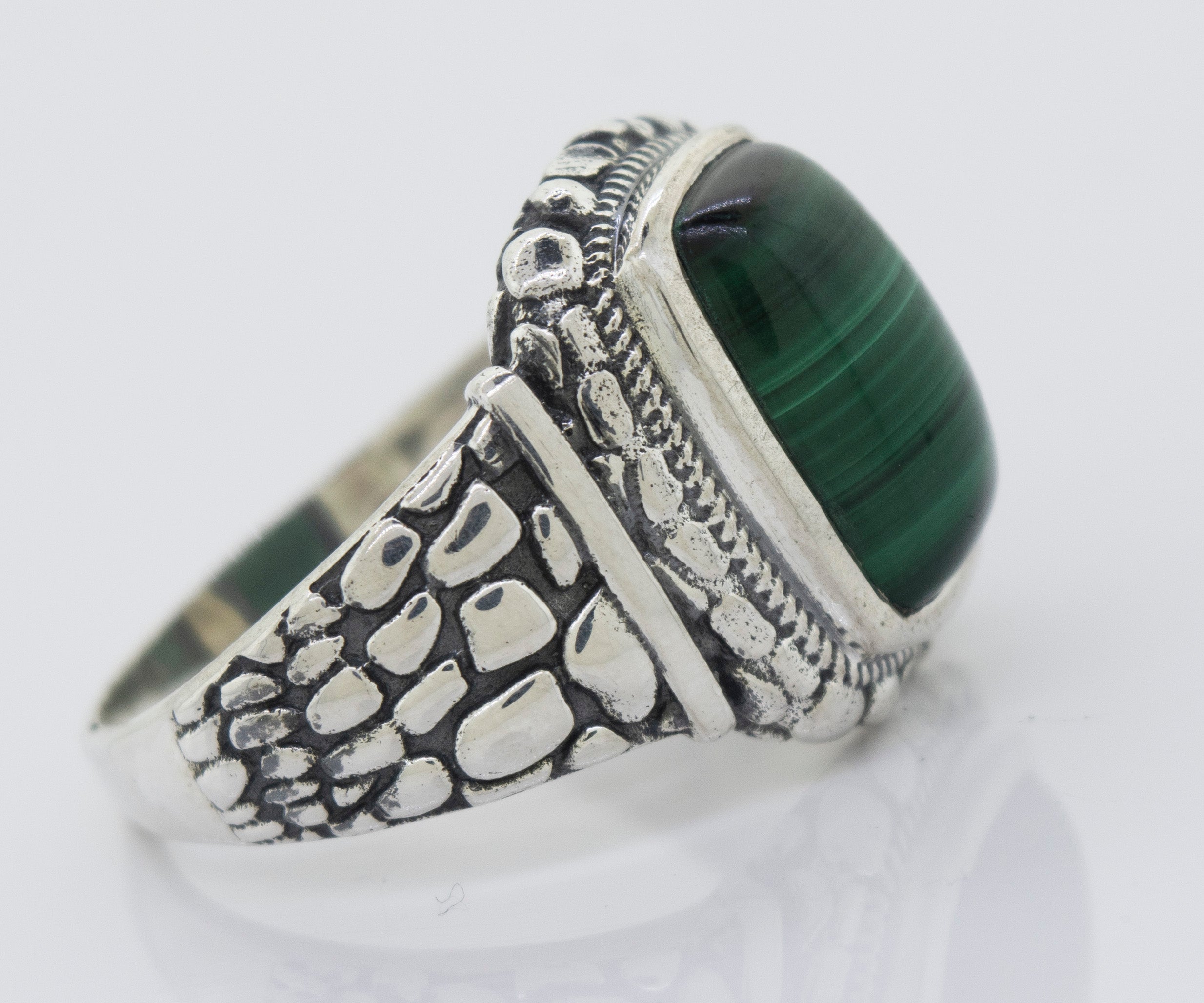 A minimalist Malachite Signet Ring With Dragon Scale Pattern.