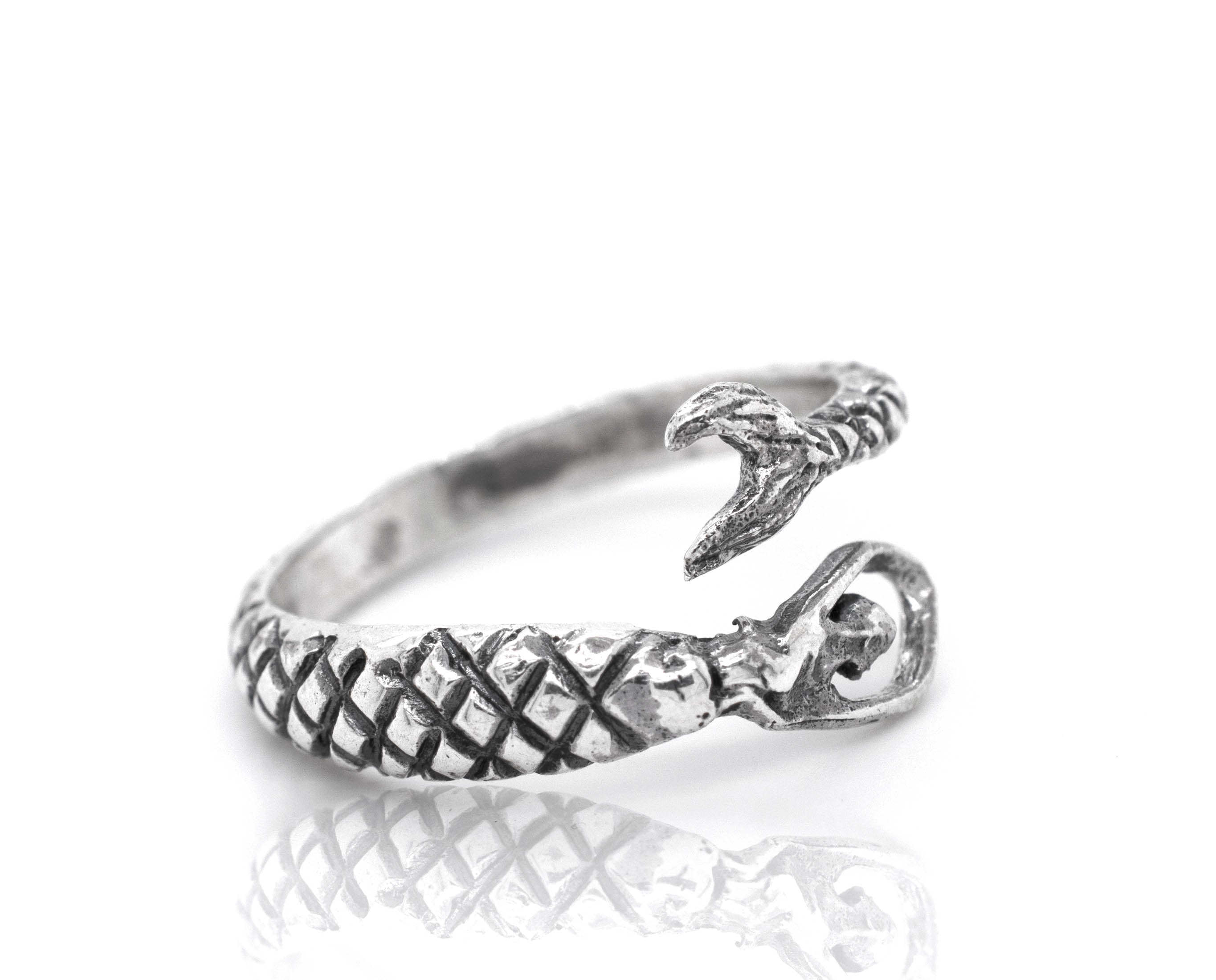 A Trendy Adjustable Mermaid Ring with a fish on it.