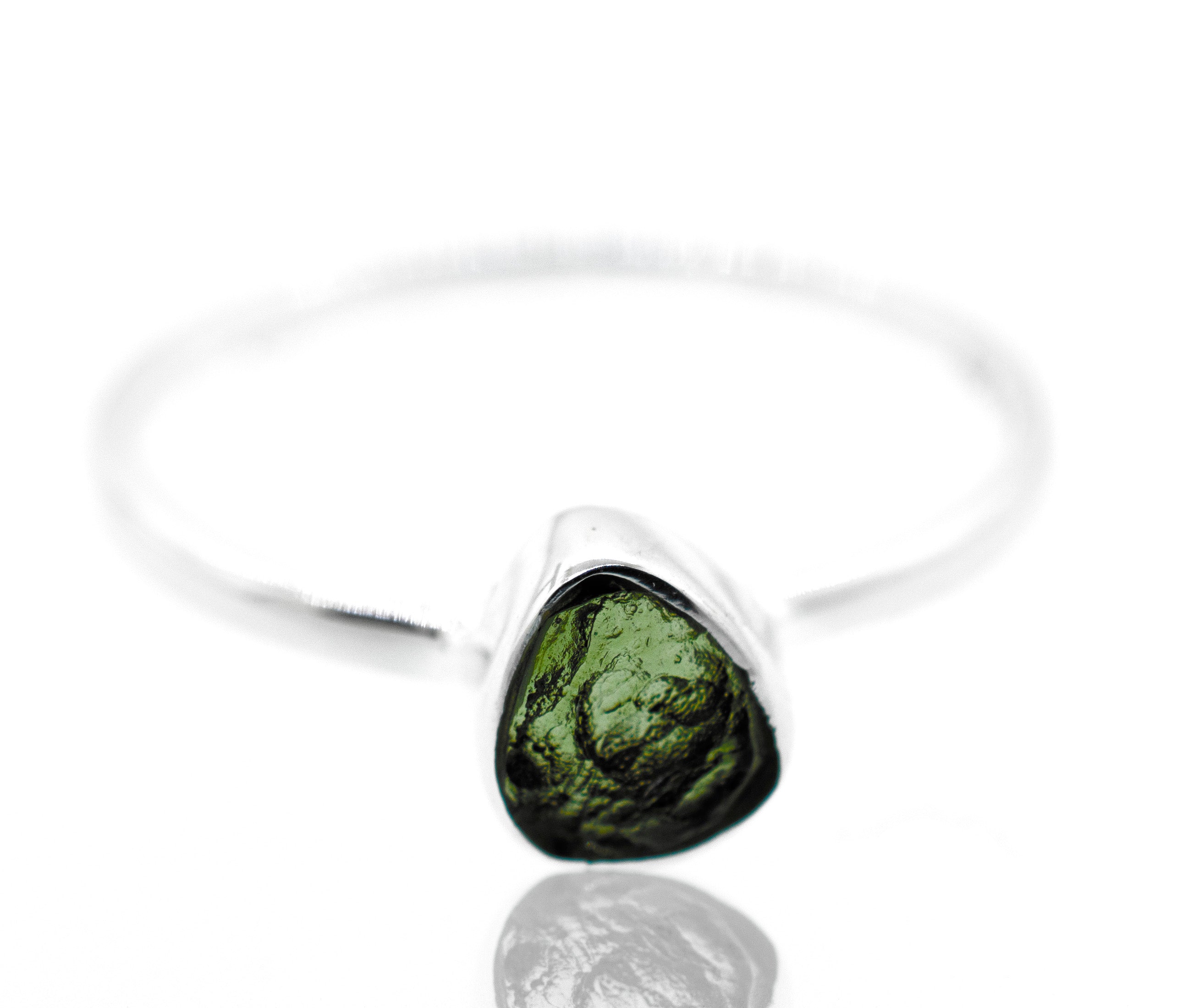 A Super Silver raw moldavite ring set in a sterling silver setting.