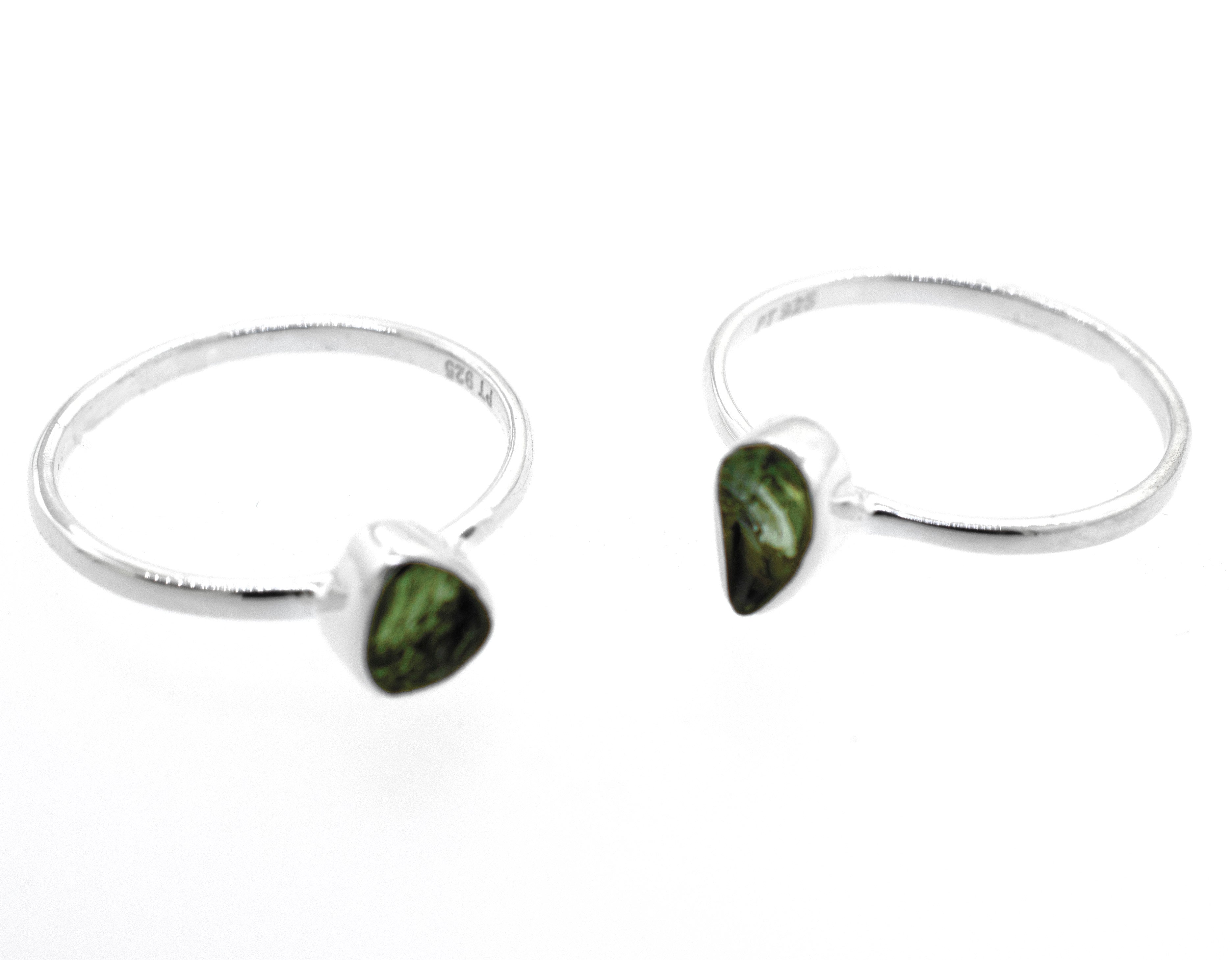 A pair of Super Silver raw moldavite rings.