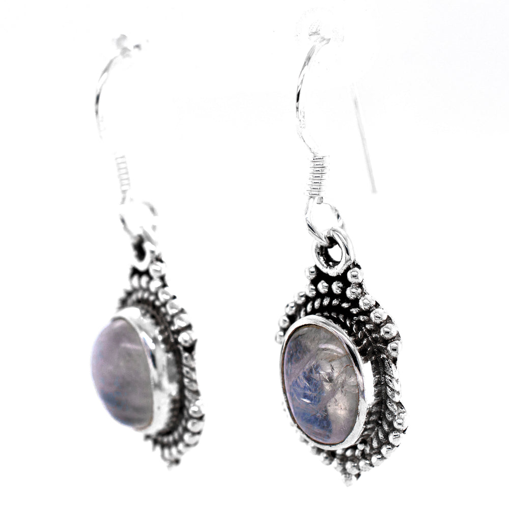 A pair of Super Silver Luminous Oval Moonstone Earrings with a blue stone.