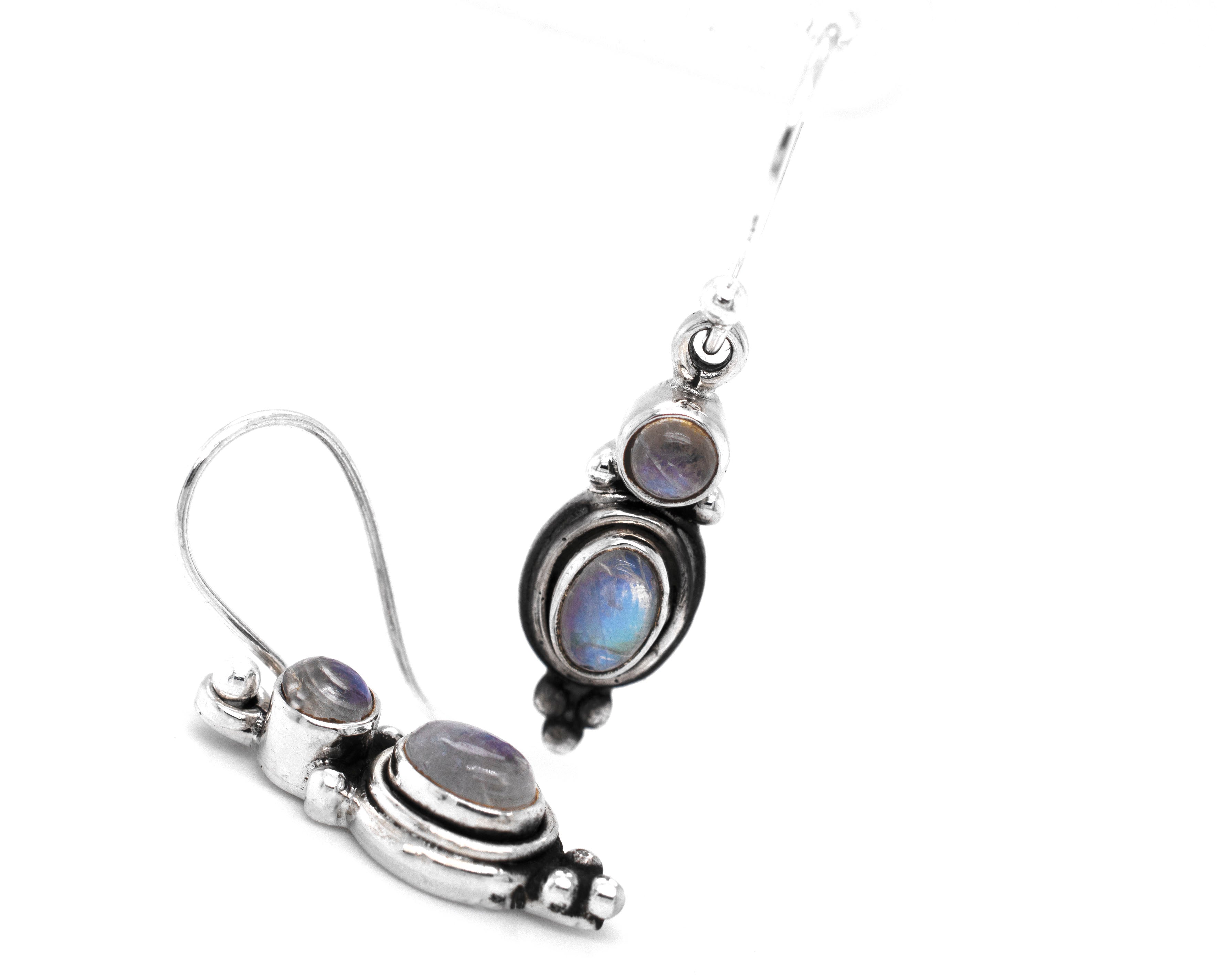 A pair of Super Silver Goddess Shape Gemstone Earrings with blue moonstones. These elegant stone earrings are adorned with beautiful blue moonstones, creating a captivating and enchanting look.