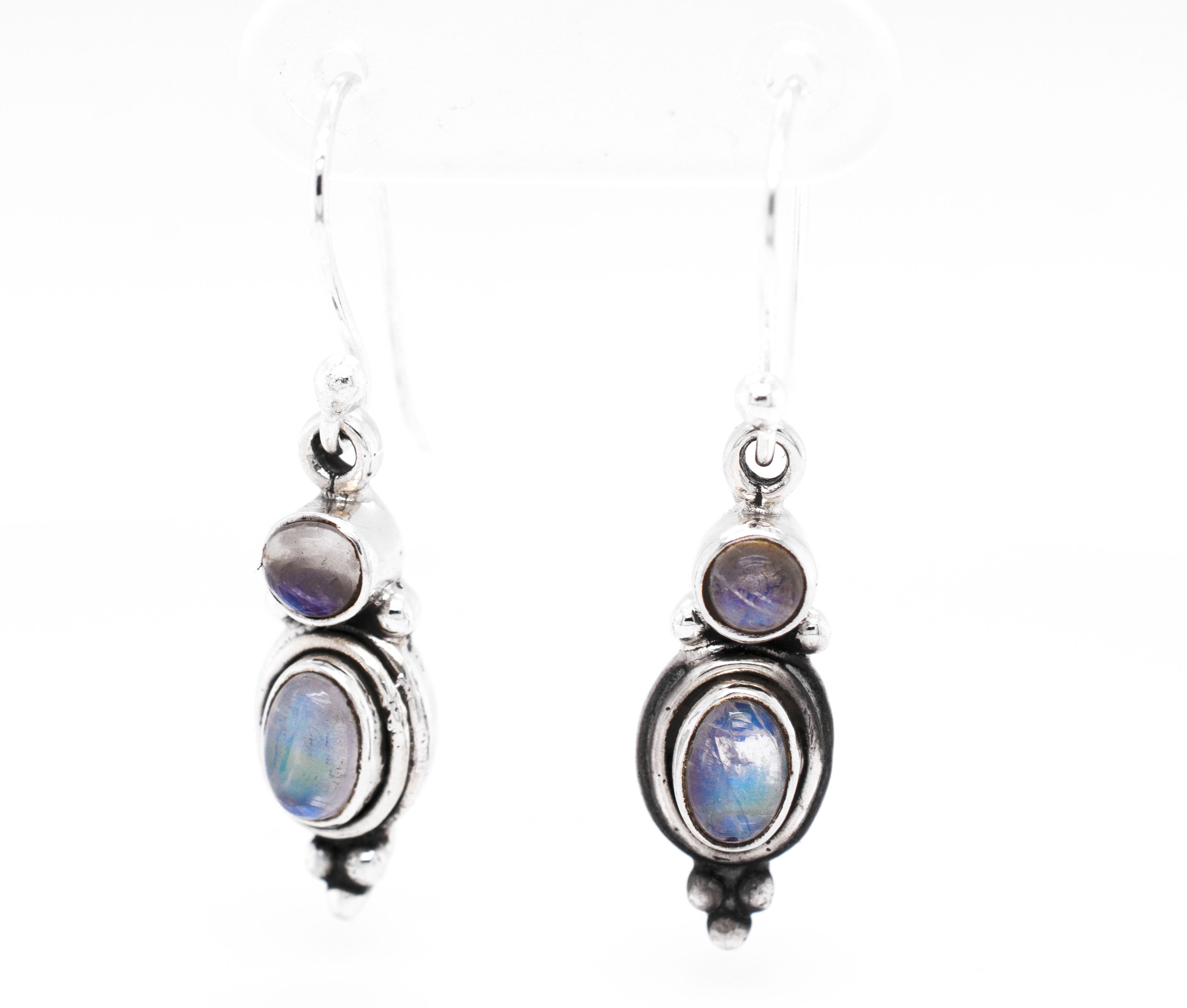 A pair of Goddess Shape Gemstone Earrings by Super Silver with blue opal stones.