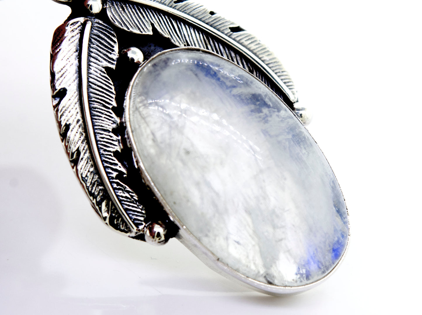 A Super Silver moonstone pendant with feathers.