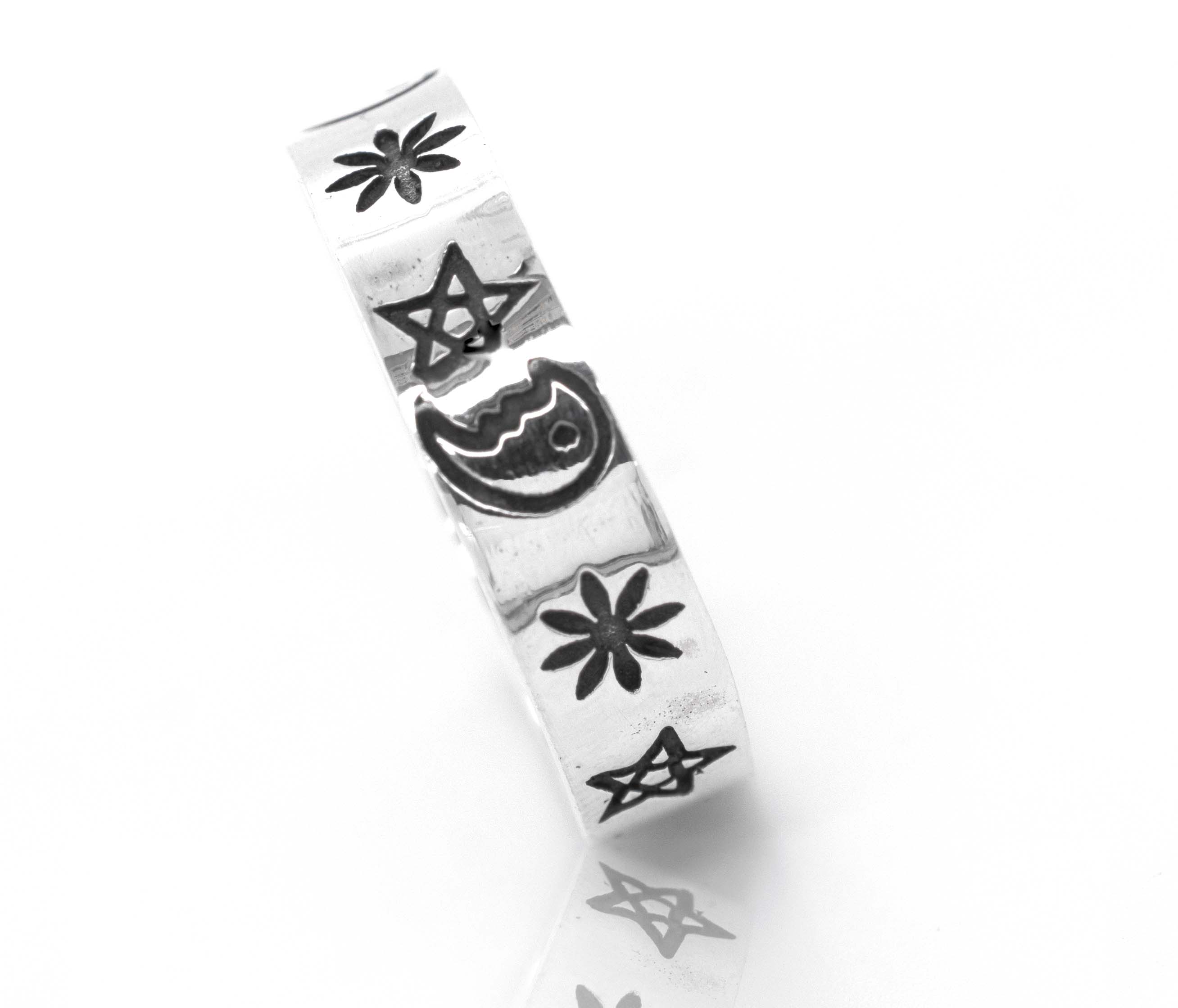 A Super Silver sterling silver band adorned with an etched crescent moon and star shape design.