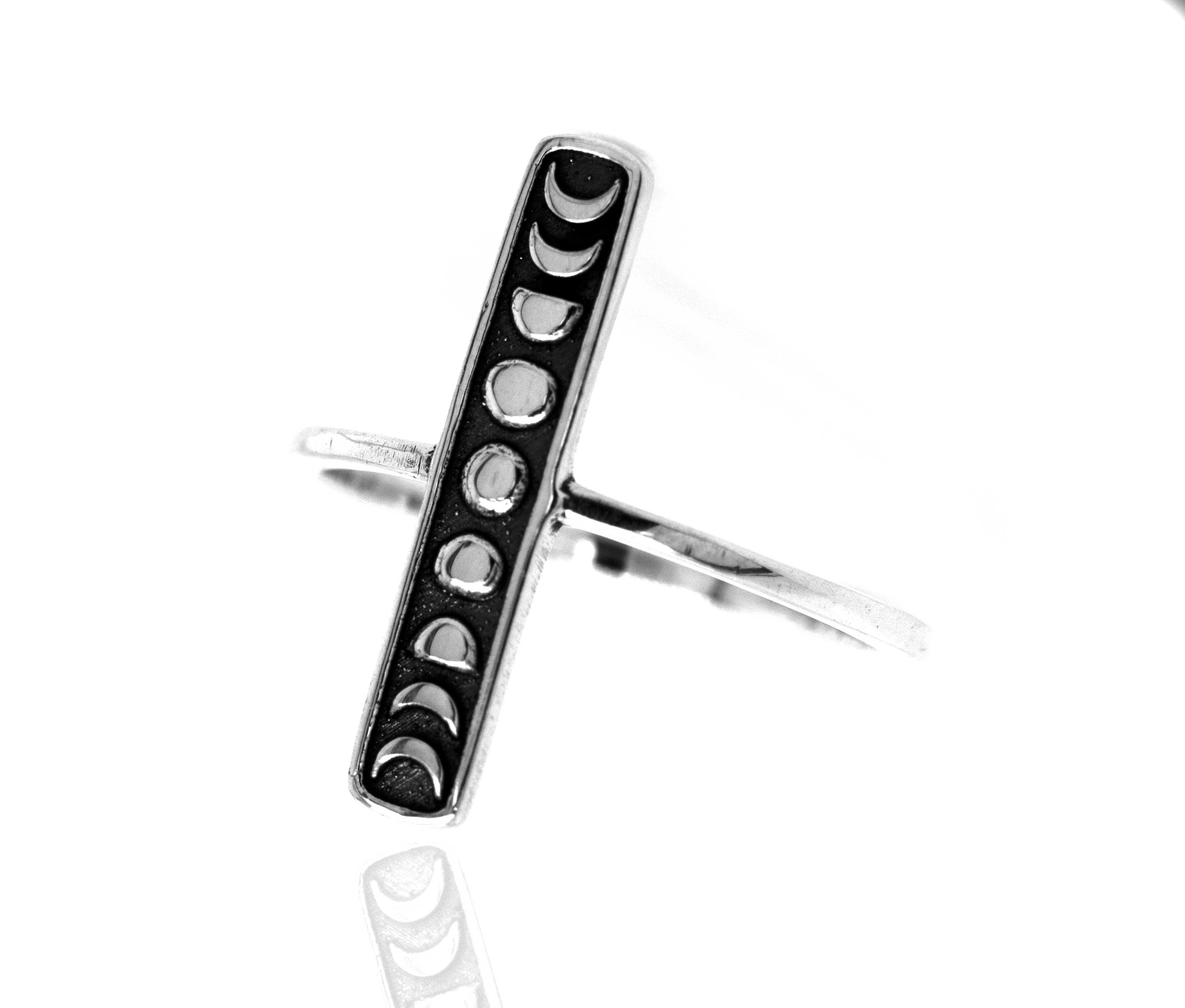 A minimalist Elongated Moon Phases Ring by Super Silver, showcasing the phases of the moon.
