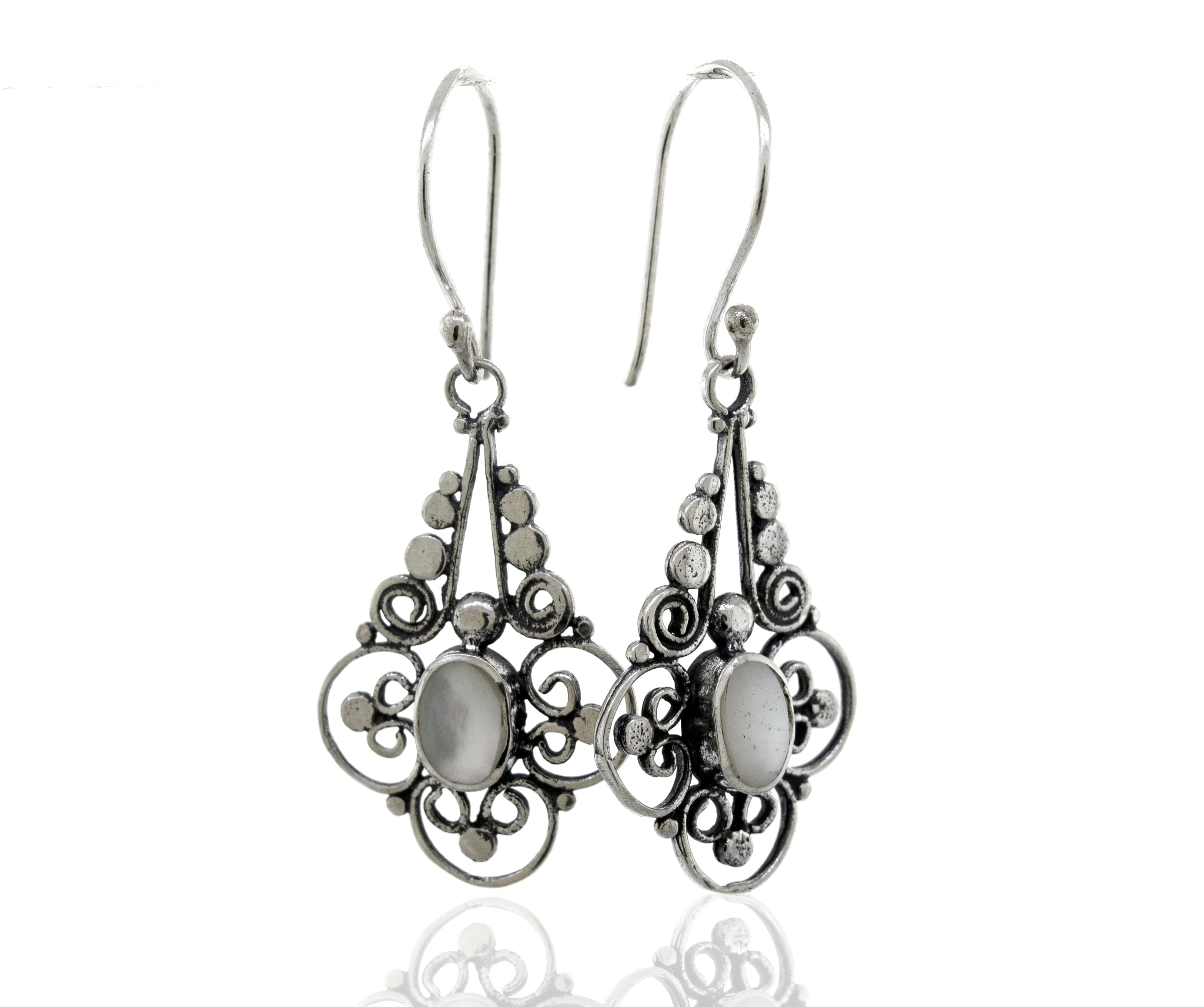 A pair of Super Silver Oval Mother Of Pearl Dangle Earrings With A Flower Design.