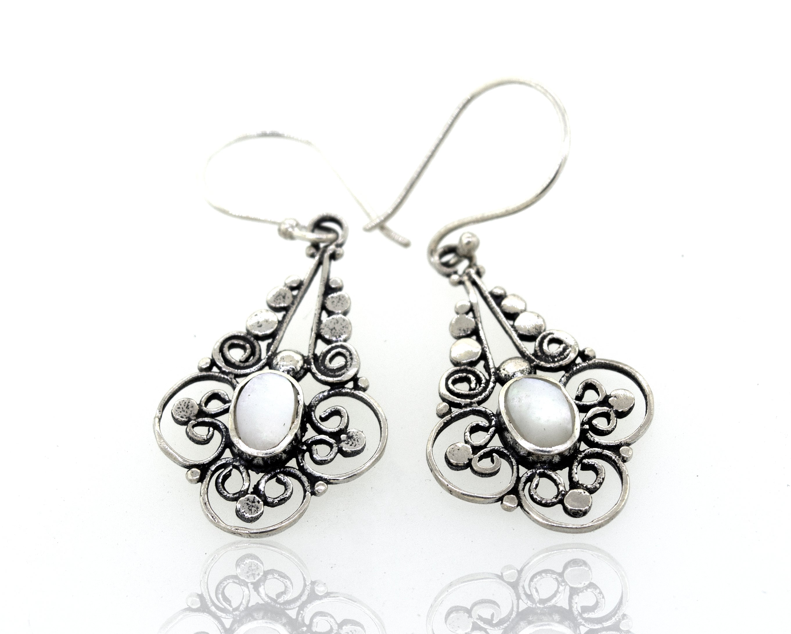 A pair of Oval Mother Of Pearl Dangle Earrings with a flower design from Super Silver.