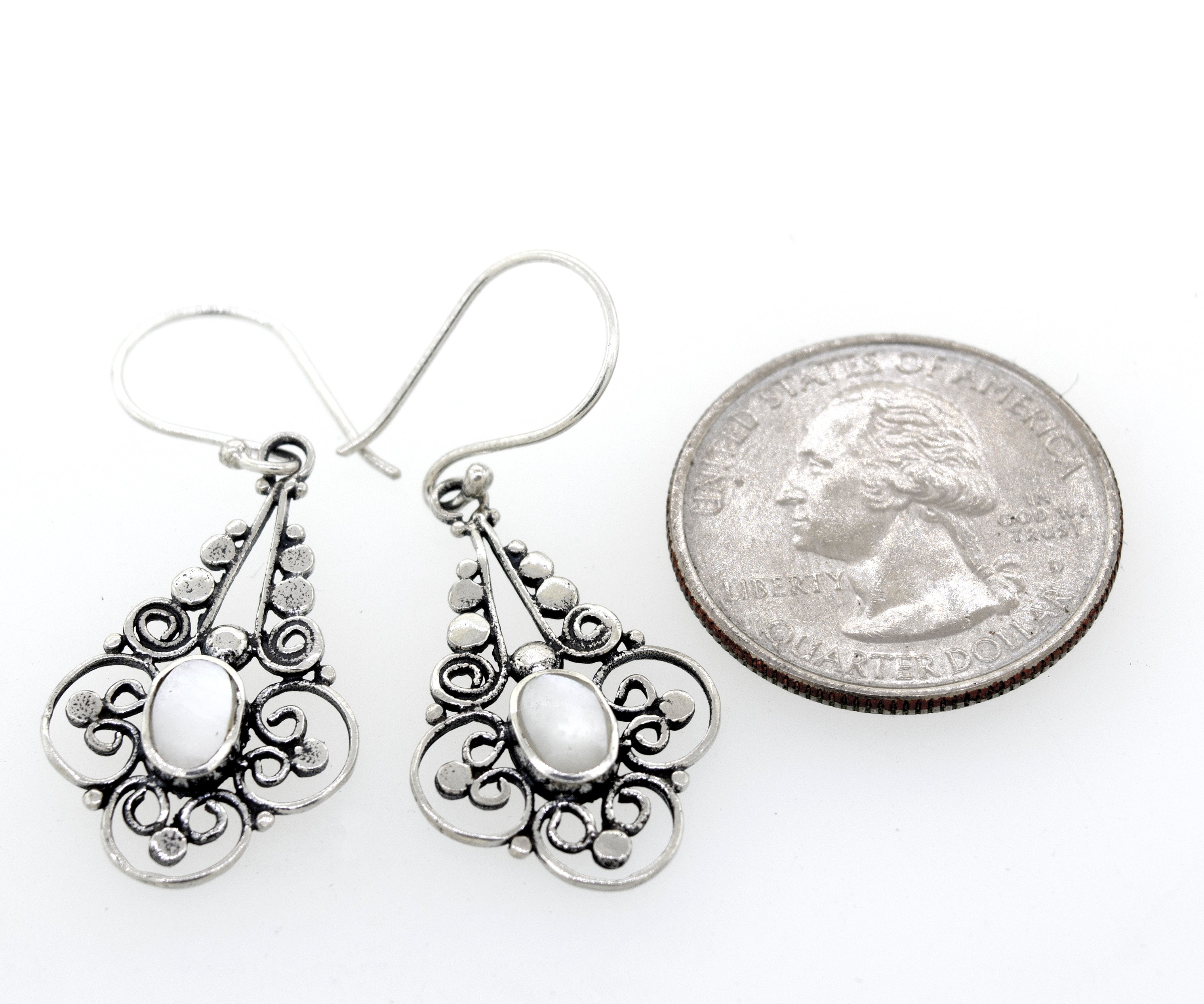 A pair of Super Silver Oval Mother Of Pearl Dangle Earrings with a Flower Design adorned with lustrous white pearls.