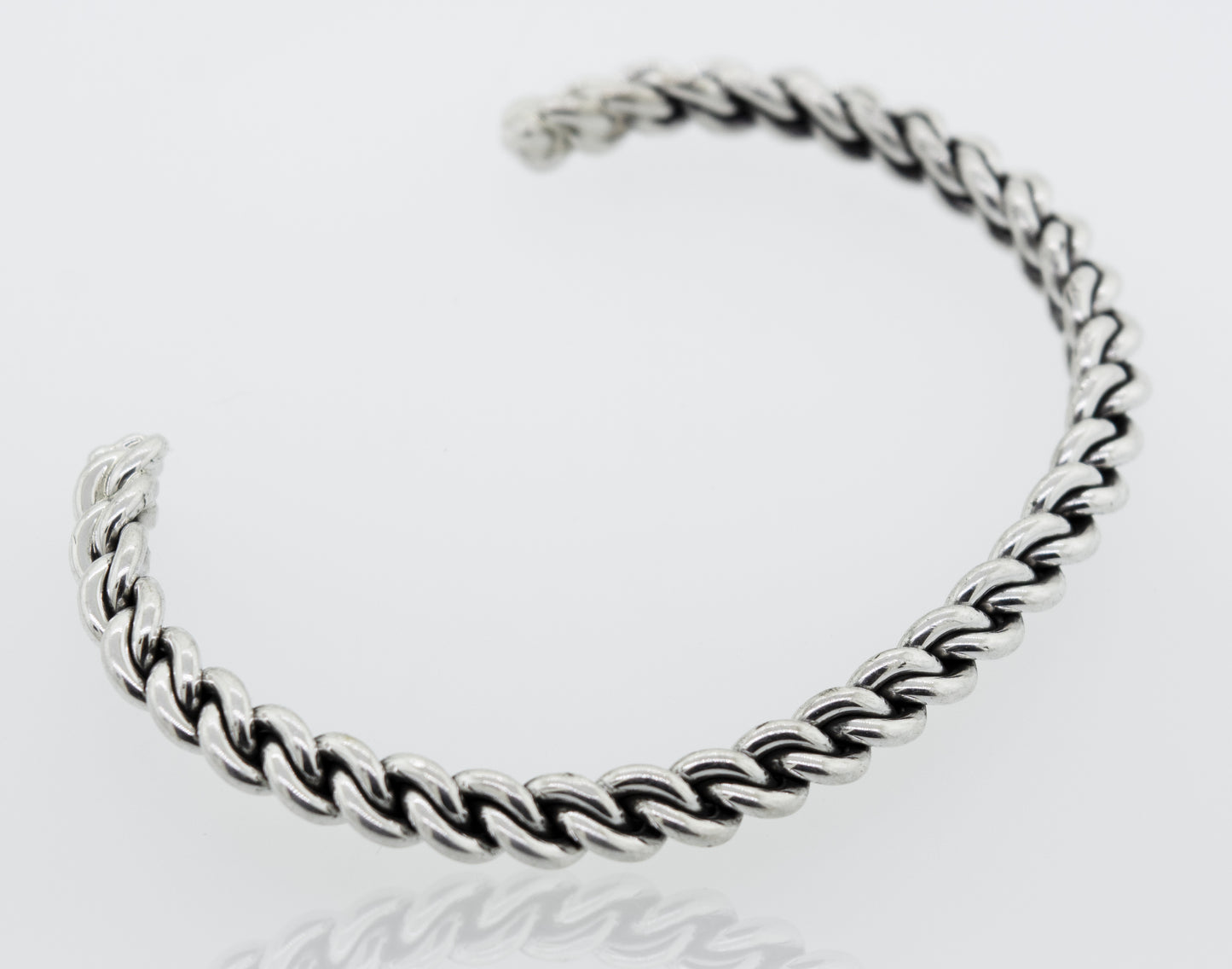 An elegant Native American Handmade Silver Woven Link Bracelet by Super Silver on a white surface.