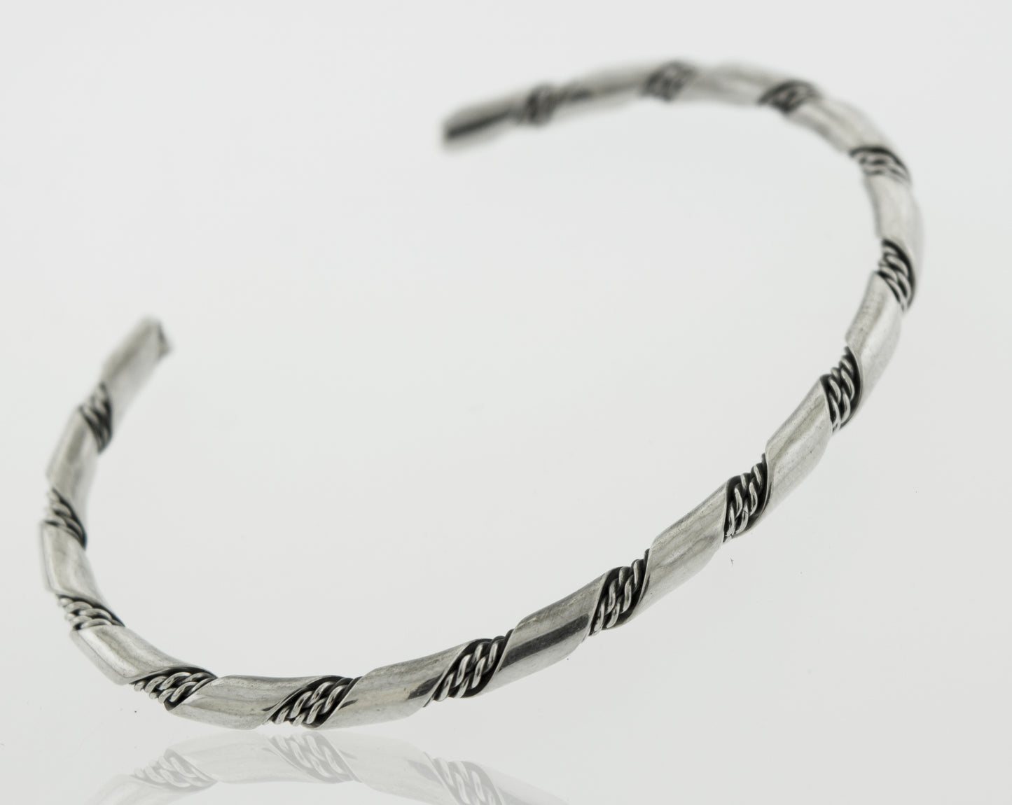 Addition: A stunning Native American Handmade Thin Silver Twist Cuff bracelet by Super Silver, perfect for adding a touch of elegance to any outfit.