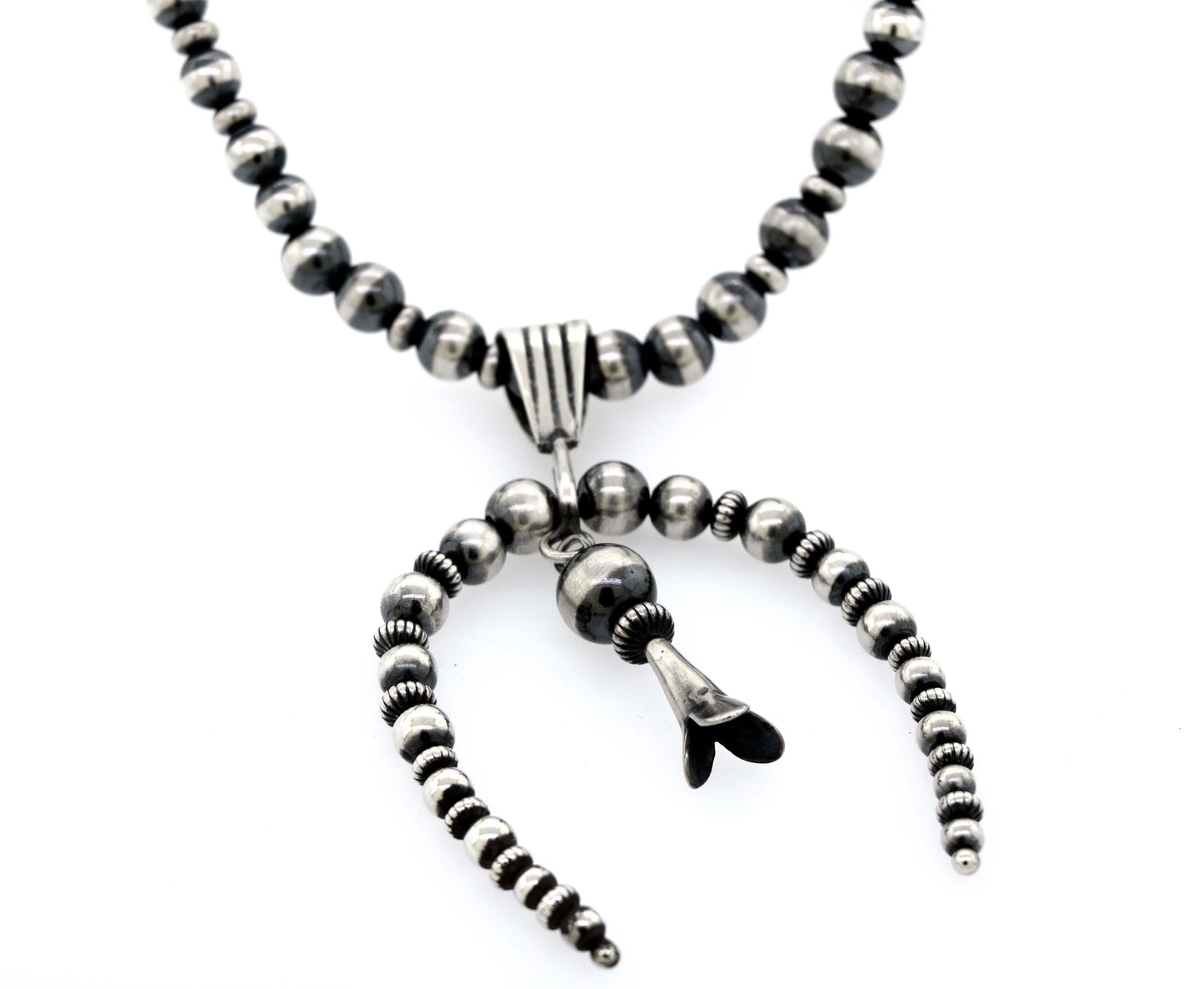 
                  
                    A Super Silver Handcrafted Naja Beaded Necklace adorned with black and white Navajo pearls, offering a sense of protection.
                  
                