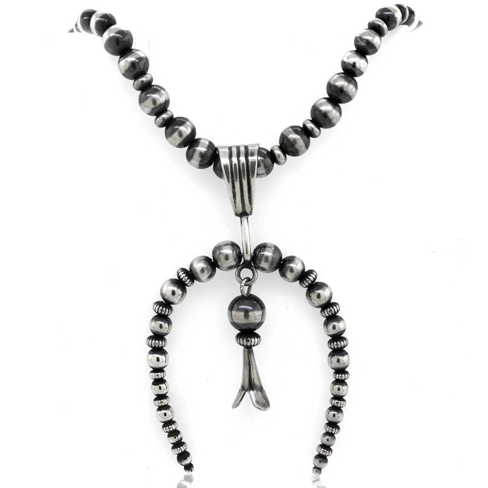 
                  
                    A Super Silver Handcrafted Naja Beaded Necklace with a silver pendant and a black bead, offering both style and protection.
                  
                