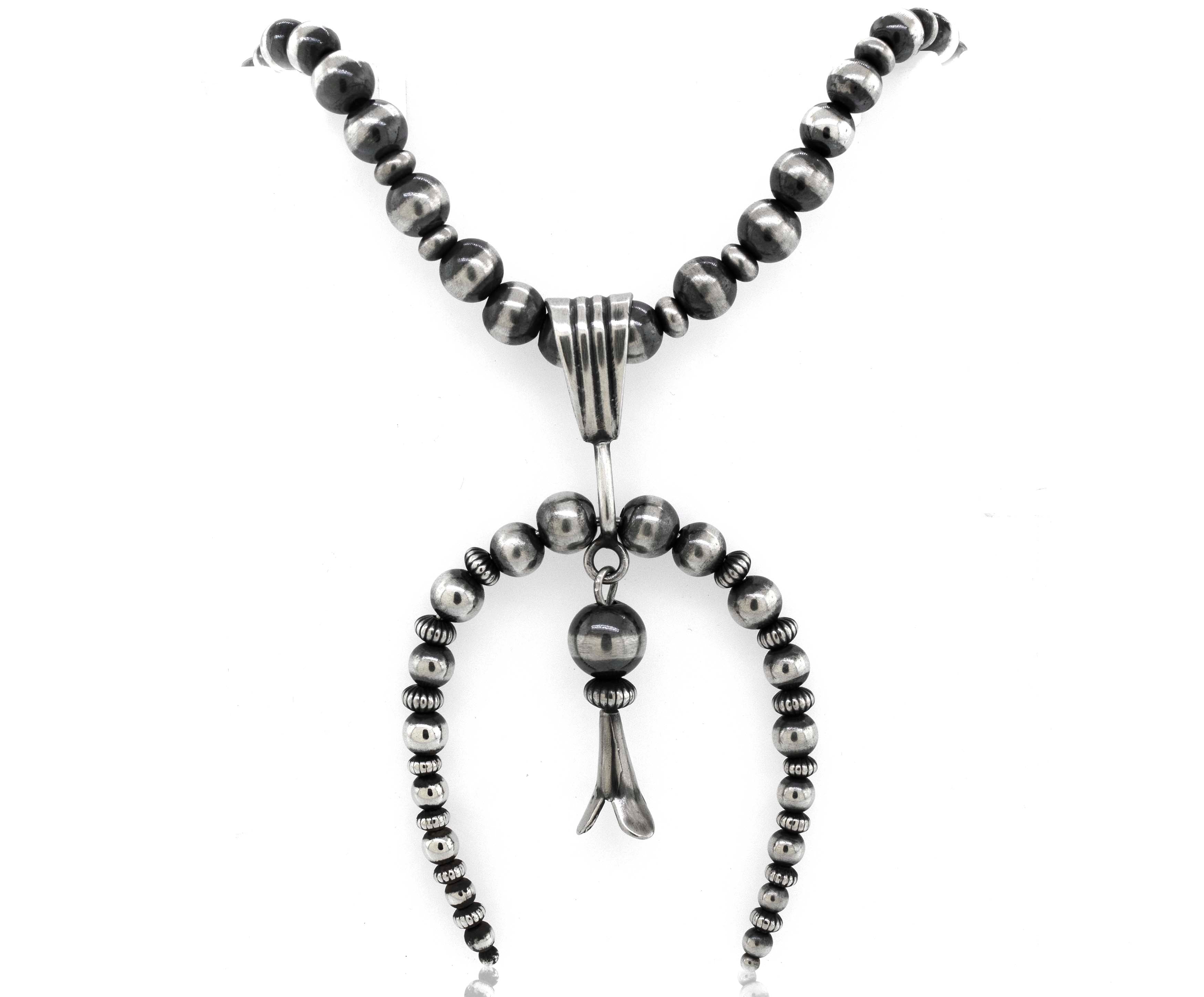 A Super Silver Handcrafted Naja Beaded Necklace with a silver pendant and a black bead, offering both style and protection.