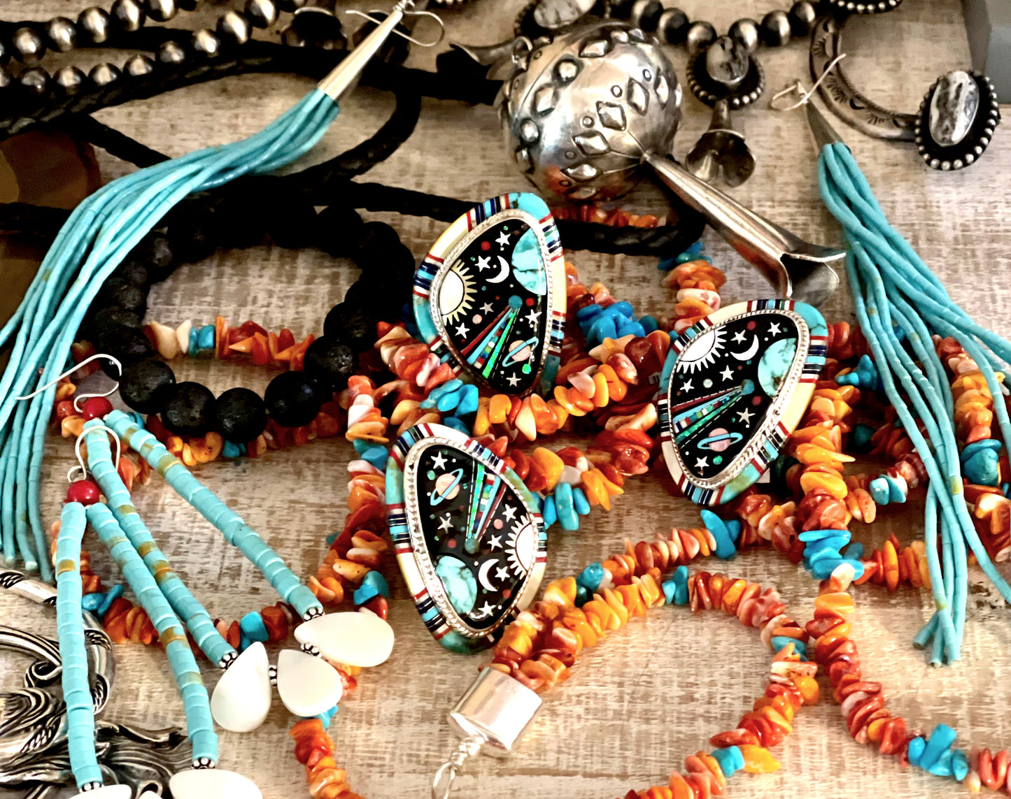 
                  
                    A table full of Super Silver's Handmade Spiny Oyster Shell and Turquoise Necklaces, spiny oyster shell bracelets, and beads.
                  
                