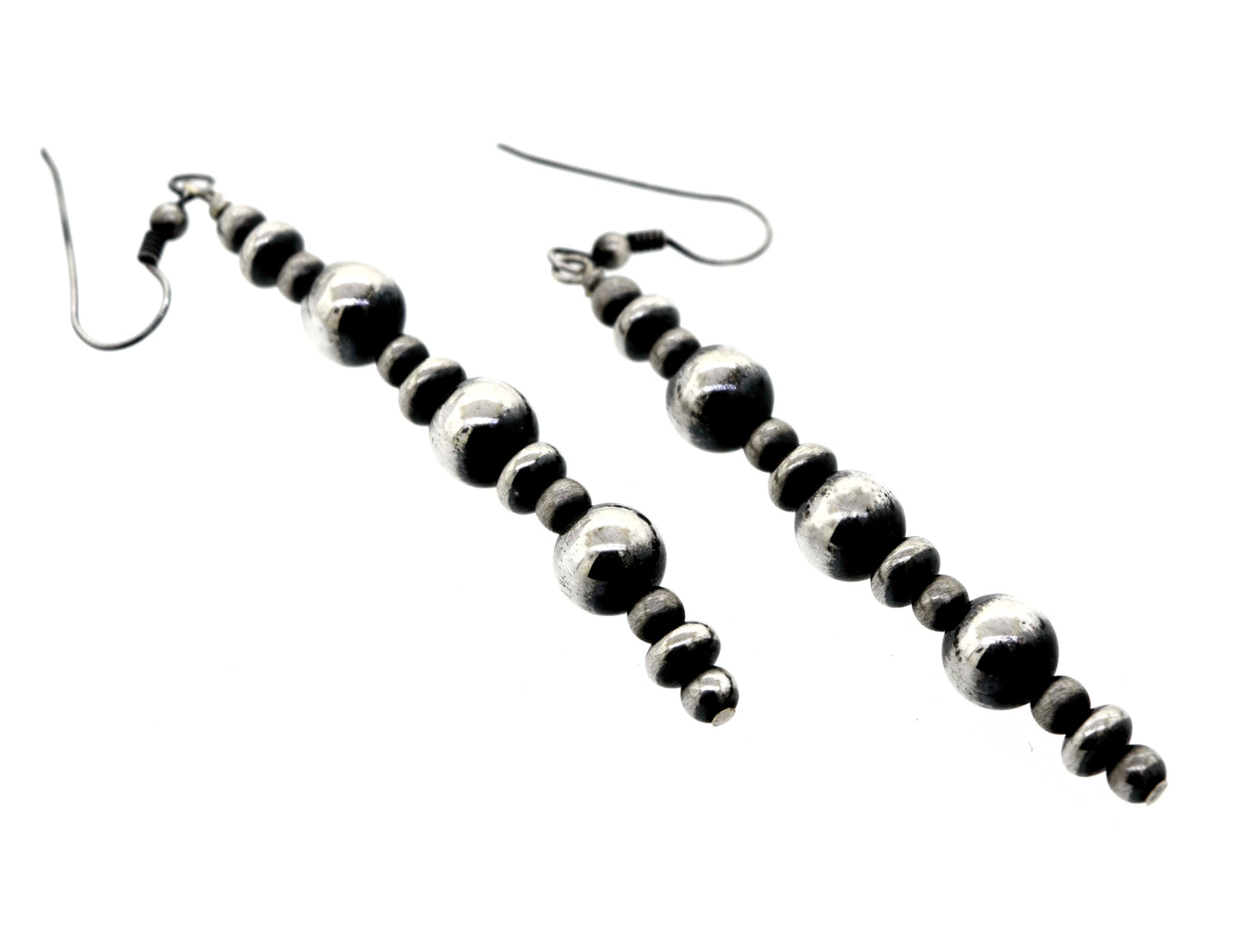 
                  
                    A pair of Long Handcrafted Navajo Pearl Earrings by Super Silver with an oxidized finish, on a white background.
                  
                