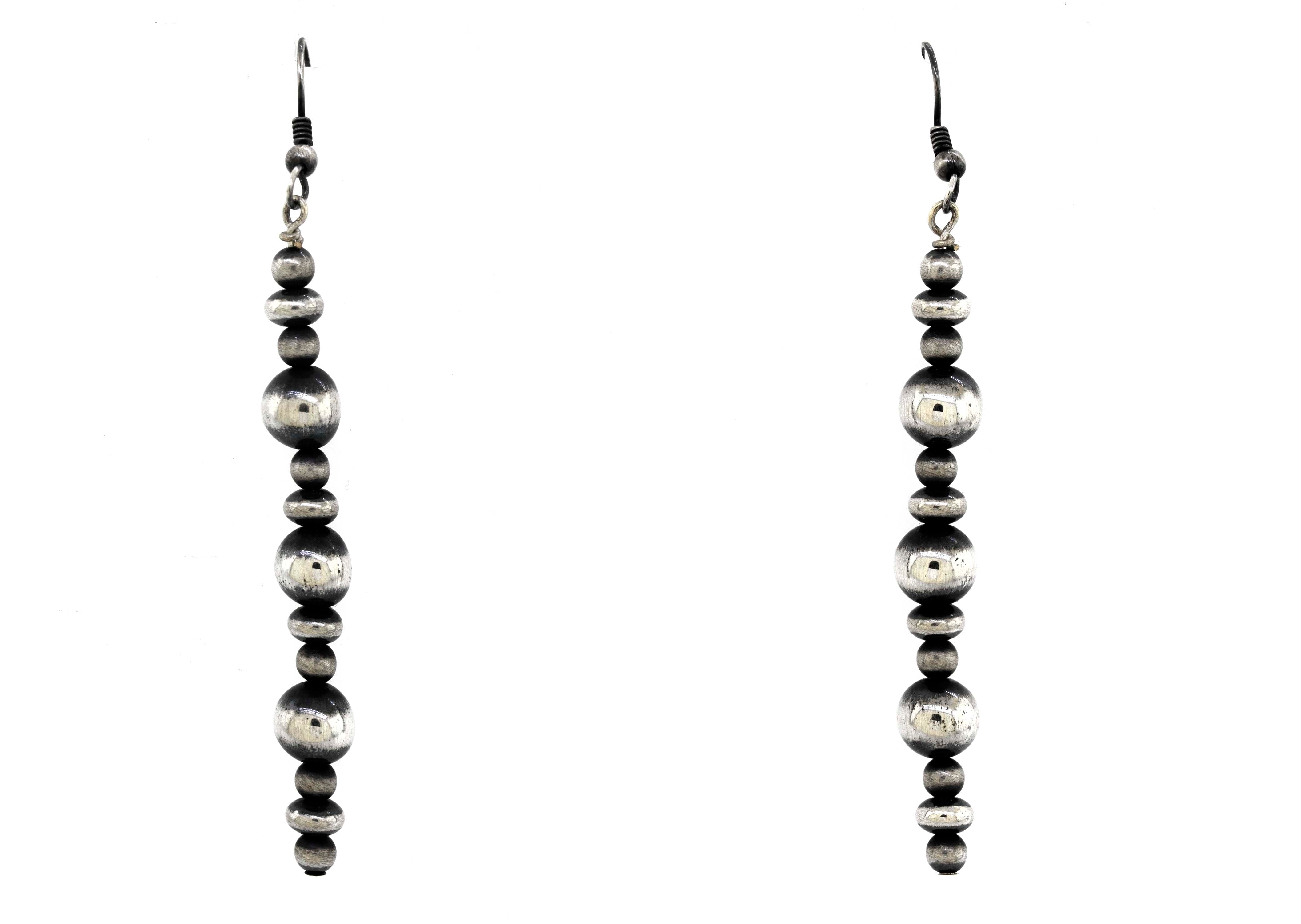 A pair of vintage-styled Super Silver Navajo pearl earrings with an oxidized finish on a white background.