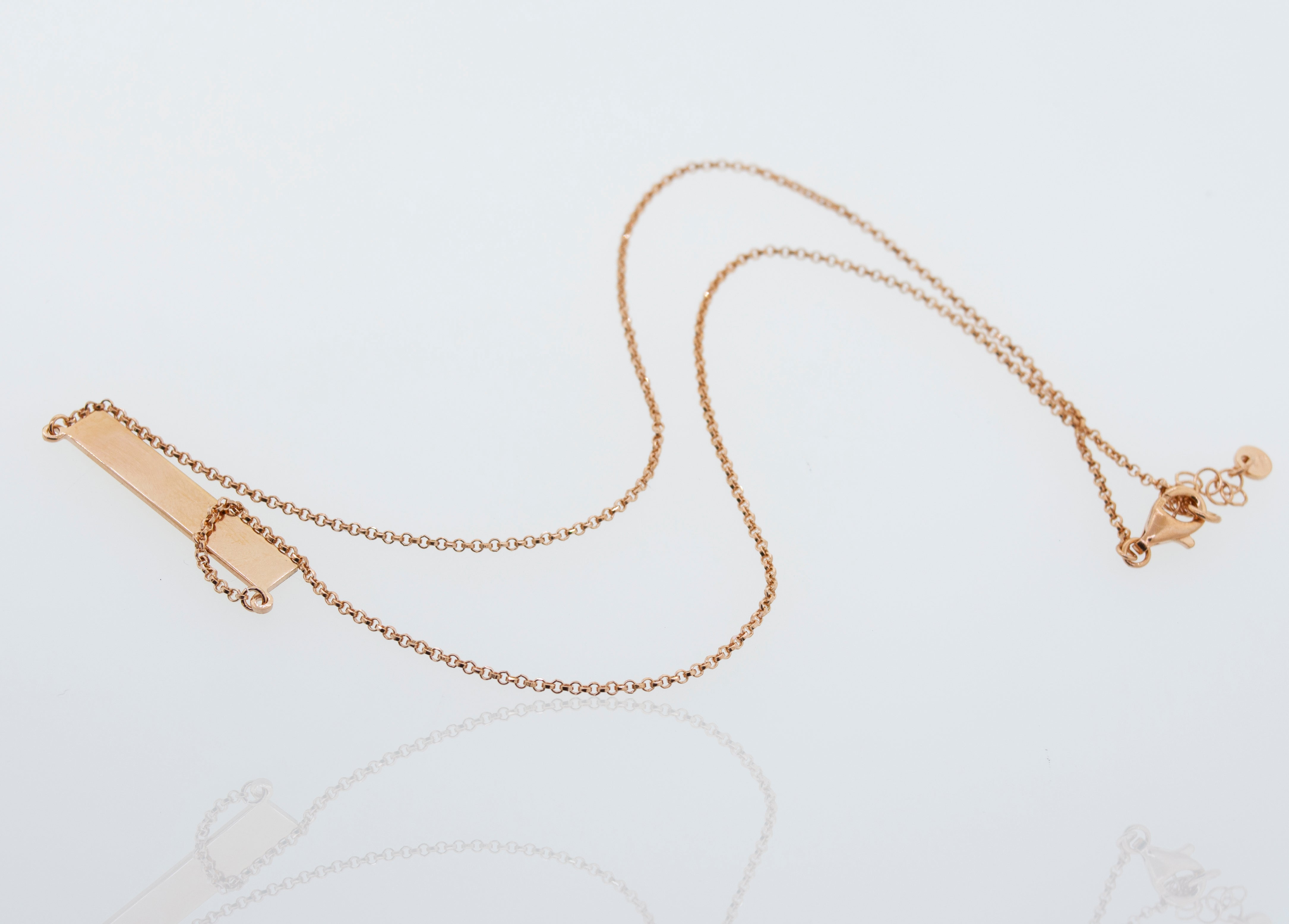 A Super Silver dainty rose gold necklace with an adjustable chain, the Dainty Nameplate Necklace.