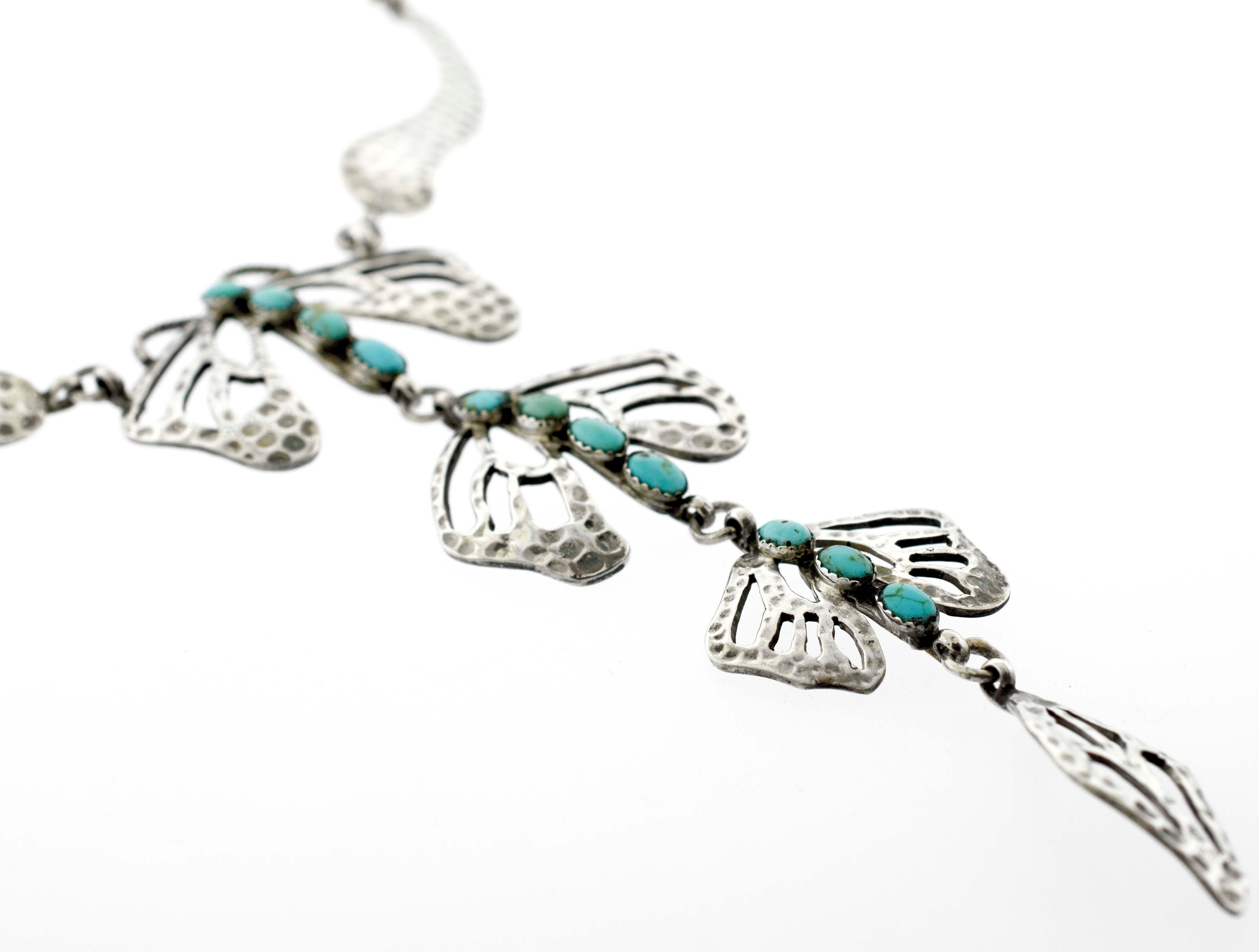 A Super Silver Handmade Turquoise Dragonfly Necklace And Earring Set adorned with delicate butterfly charms.