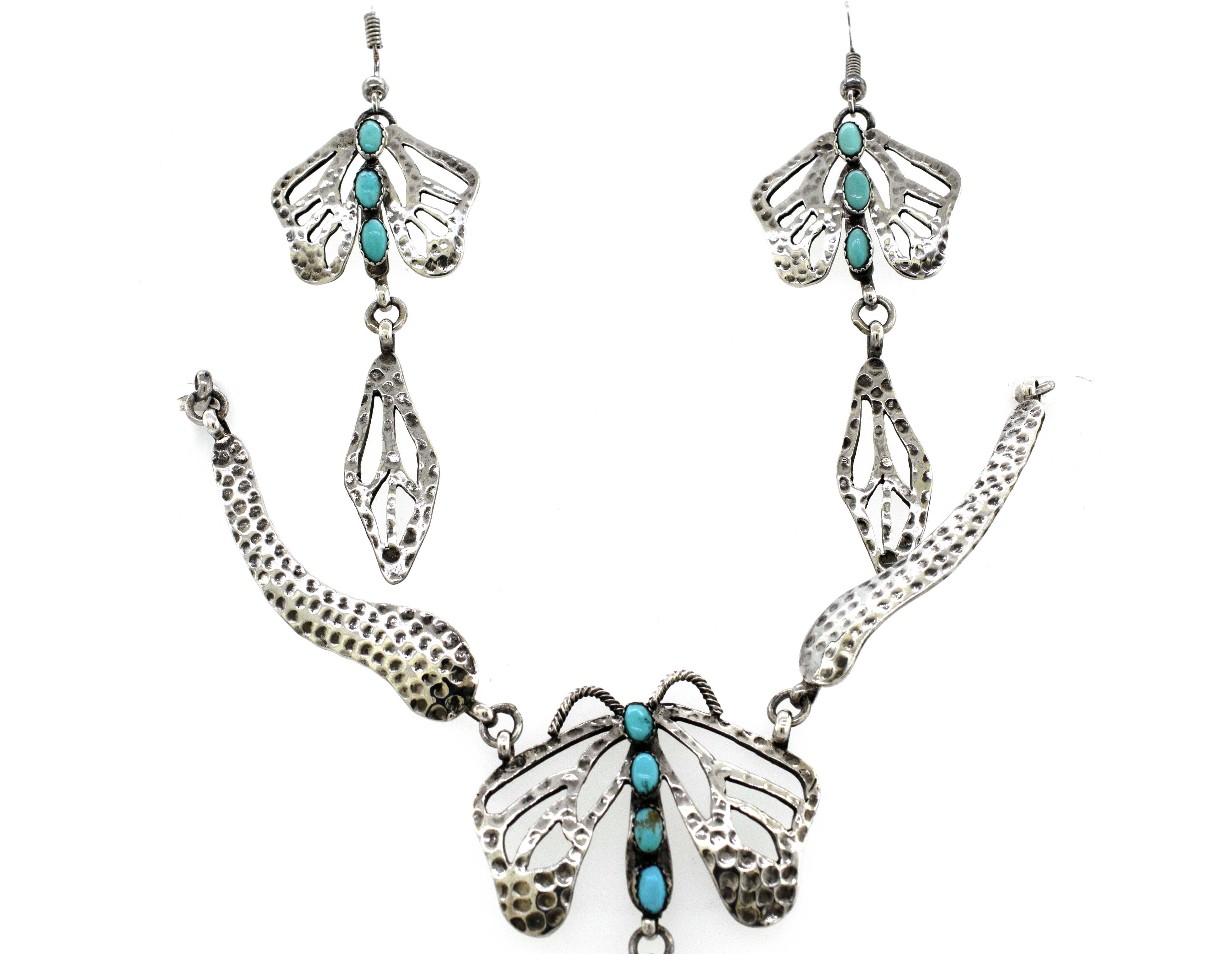 A Super Silver Handmade Turquoise Dragonfly Necklace And Earring Set with turquoise accents.