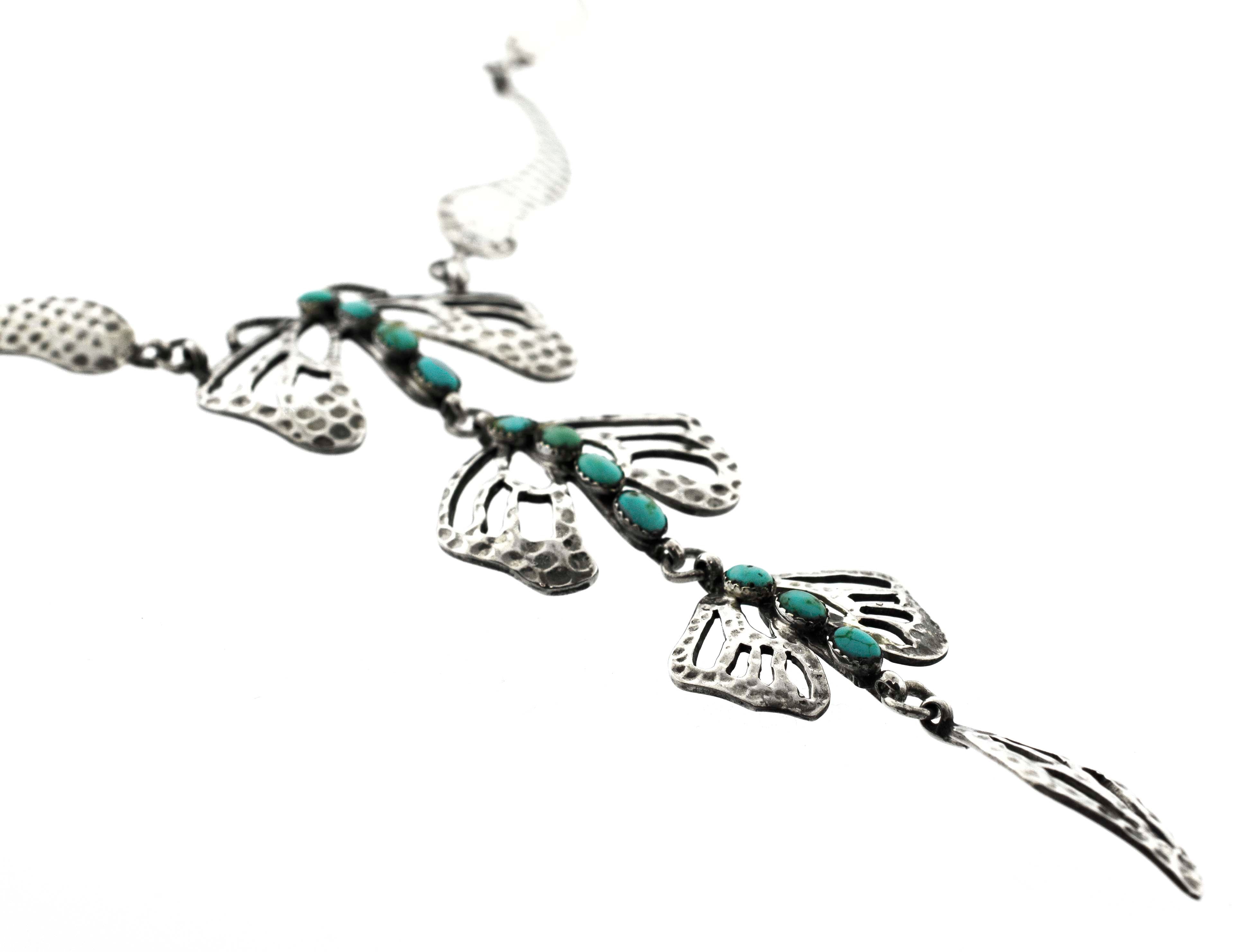 A Super Silver Handmade Turquoise Dragonfly Necklace And Earring Set adorned with turquoise beads and leaves.