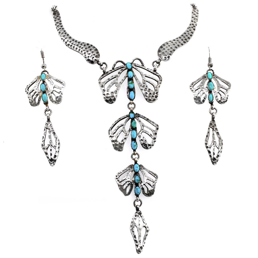 A stunning Super Silver handmade turquoise dragonfly necklace and earring set elegantly adorned with a delicate dragonfly motif.