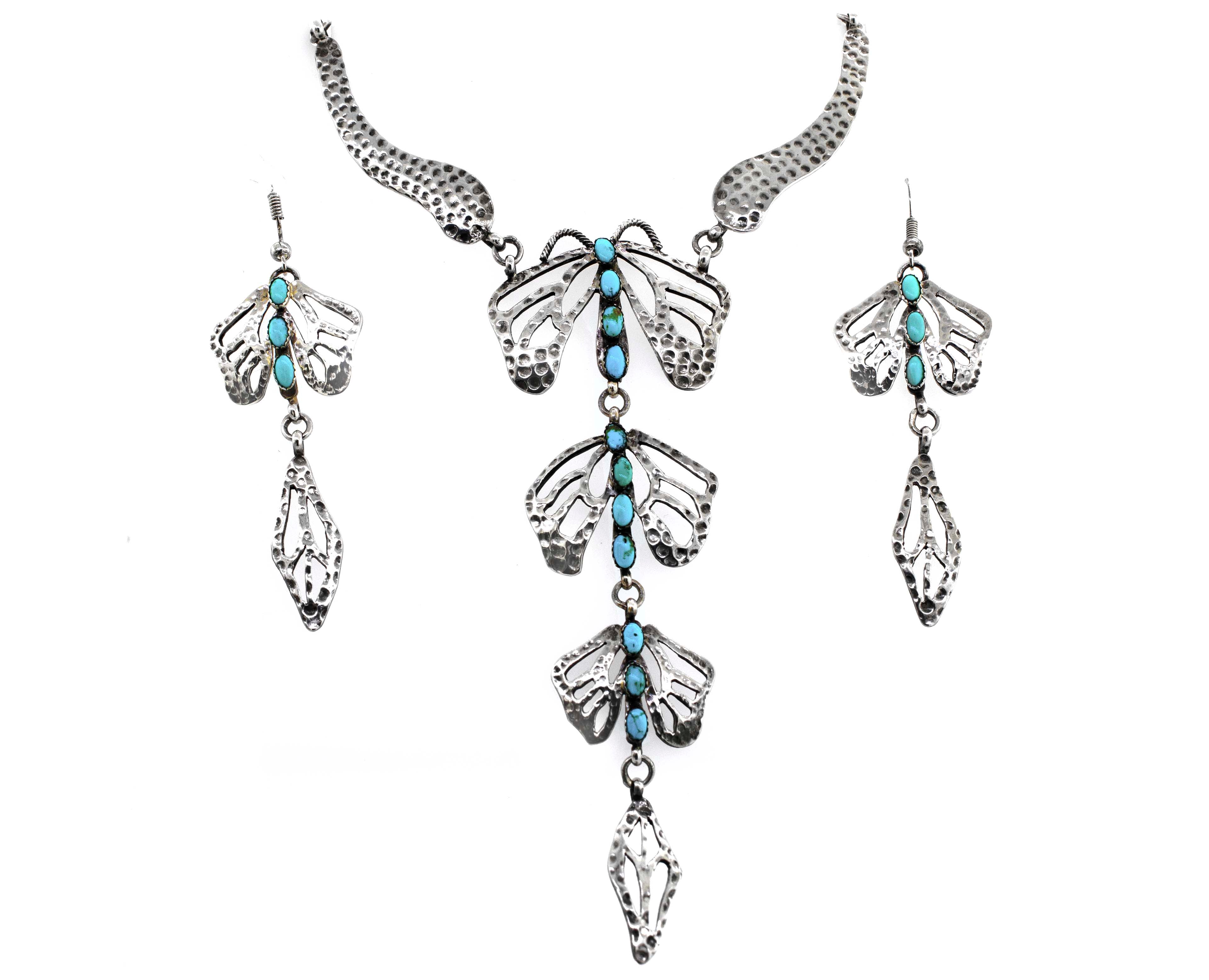 A stunning Super Silver handmade turquoise dragonfly necklace and earring set elegantly adorned with a delicate dragonfly motif.