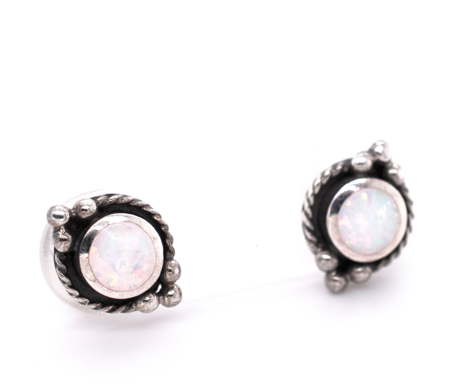 Description: Super Silver Bali style opal stud earrings featuring white opal with oxidized rope detailing, showcased on a white background.