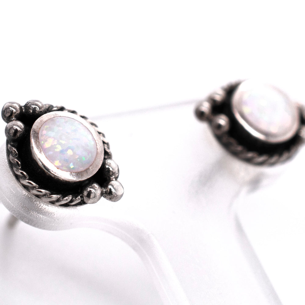 A pair of Super Silver Bali Style Opal Stud Earrings, featuring white opal, on a white background.