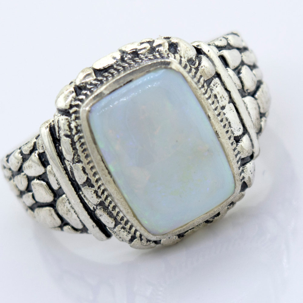 A minimalist silver ring with an Australian Opal Signet Ring With Dragon Scale Pattern.