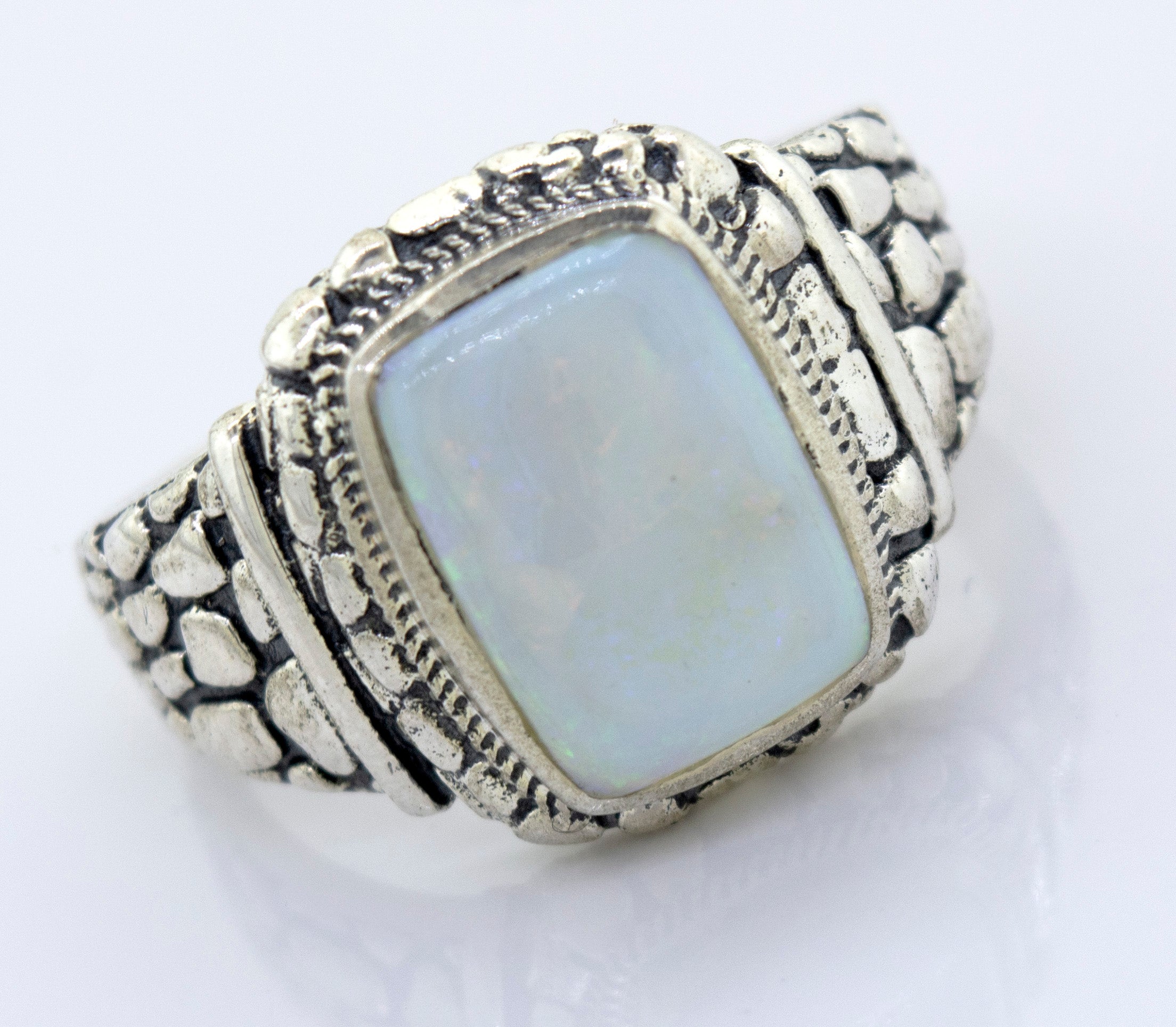 A minimalist silver ring with an Australian Opal Signet Ring With Dragon Scale Pattern.