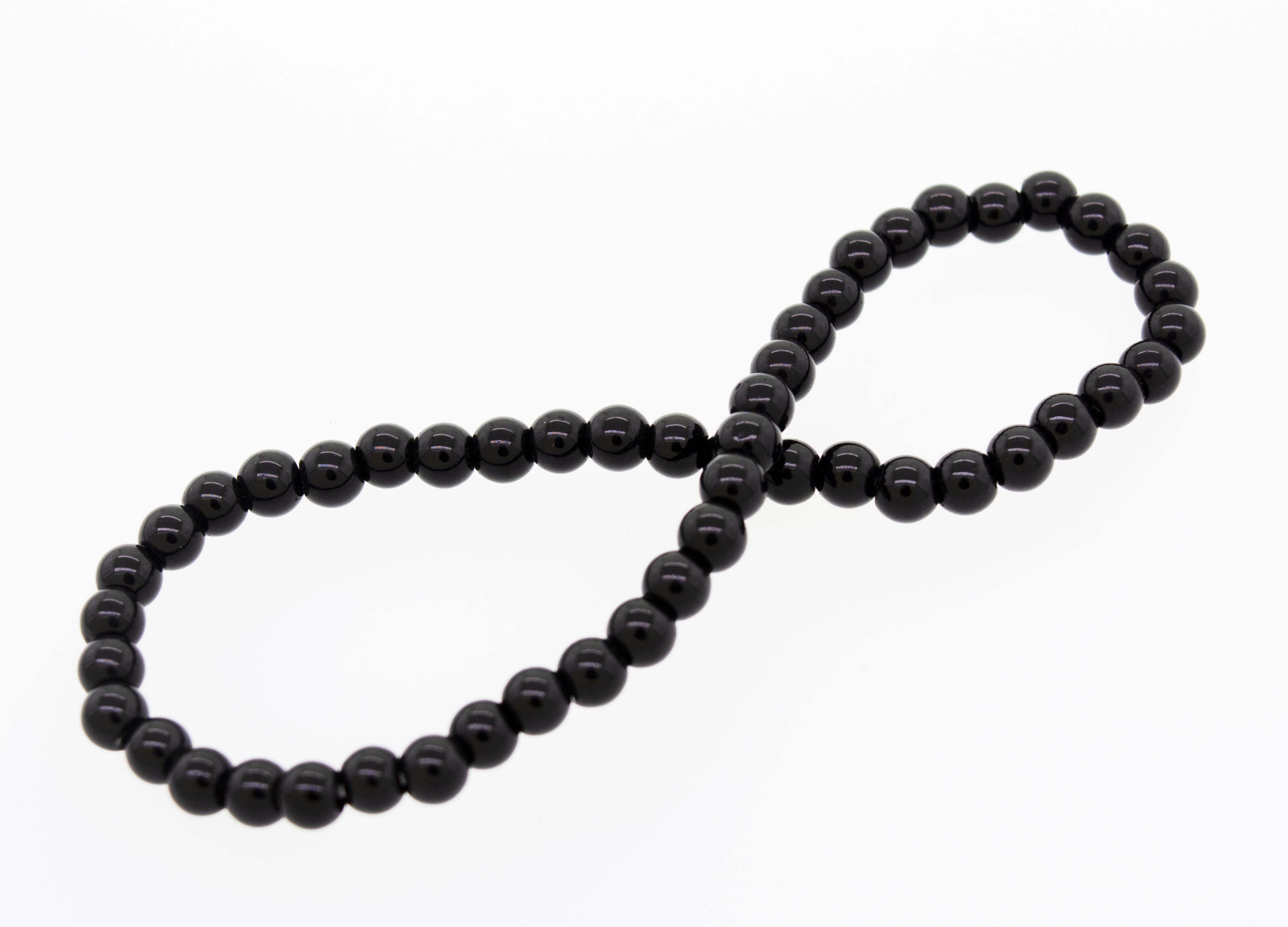 A black onyx bead on a white background, part of the Small Stone Beads Bracelet by Super Silver.