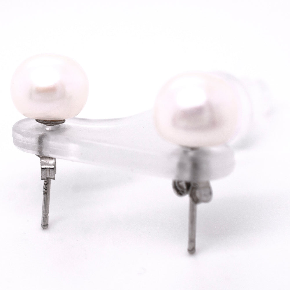 
                  
                    A pair of Classic Pearl Stud Earrings from Super Silver on a white background.
                  
                