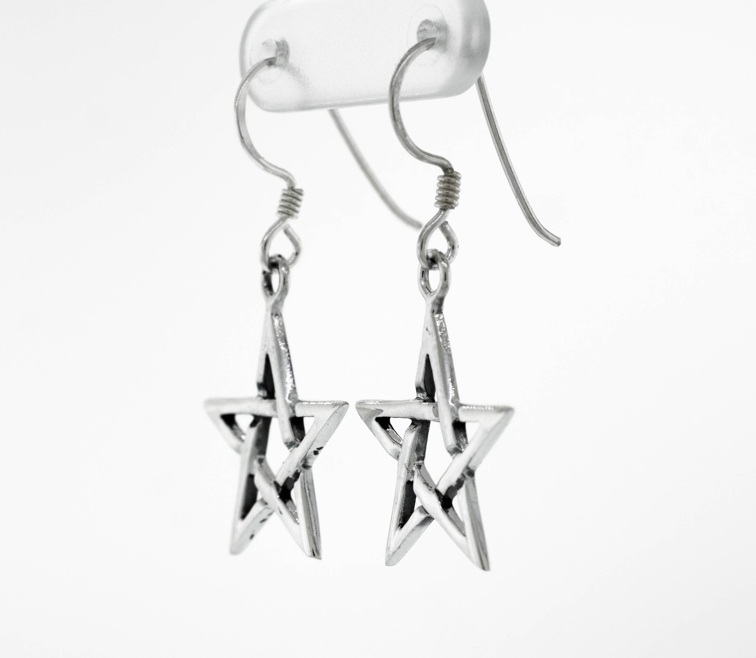 A pair of Super Silver sterling silver pentagram earrings hanging on a white background.