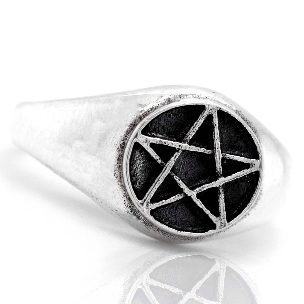 A gothic silver Pentagram Ring with a pentagram star on it.