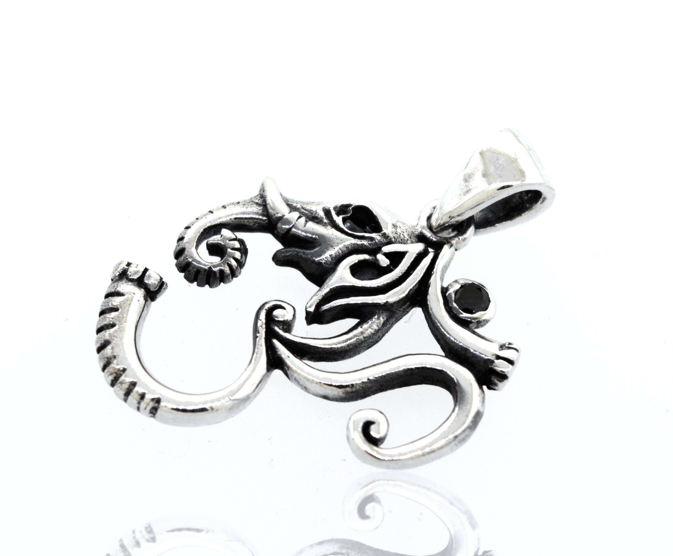 A Super Silver Om Pendant With Elephant Head Design, featuring onyx stones, placed on a white surface.
