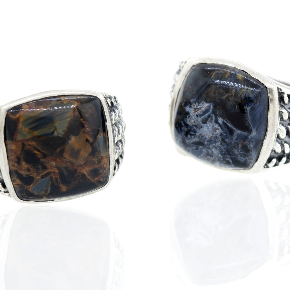 A minimalist pair of Pietersite Signet Rings with black and brown stones.
