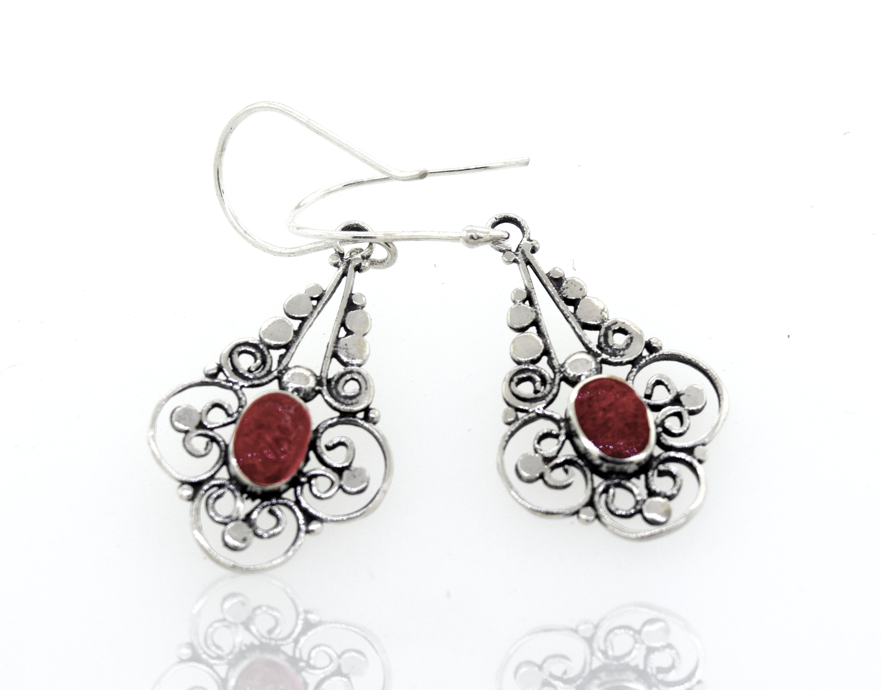 A pair of Oval Coral Dangle Earrings With A Flower Design from Super Silver, with a red stone.