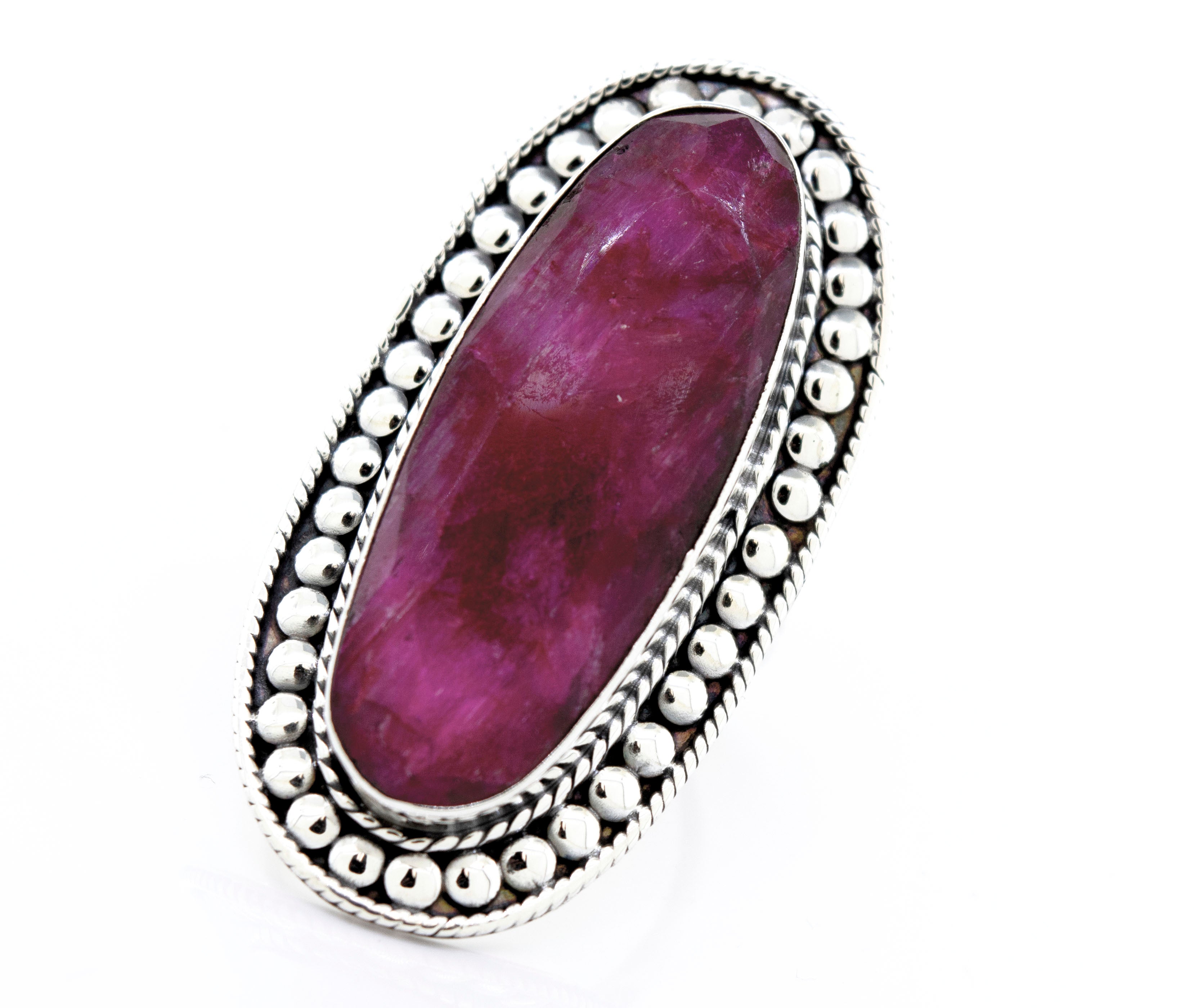 An Elegant Raw Ruby Ring with a pink stone in a Super Silver setting.