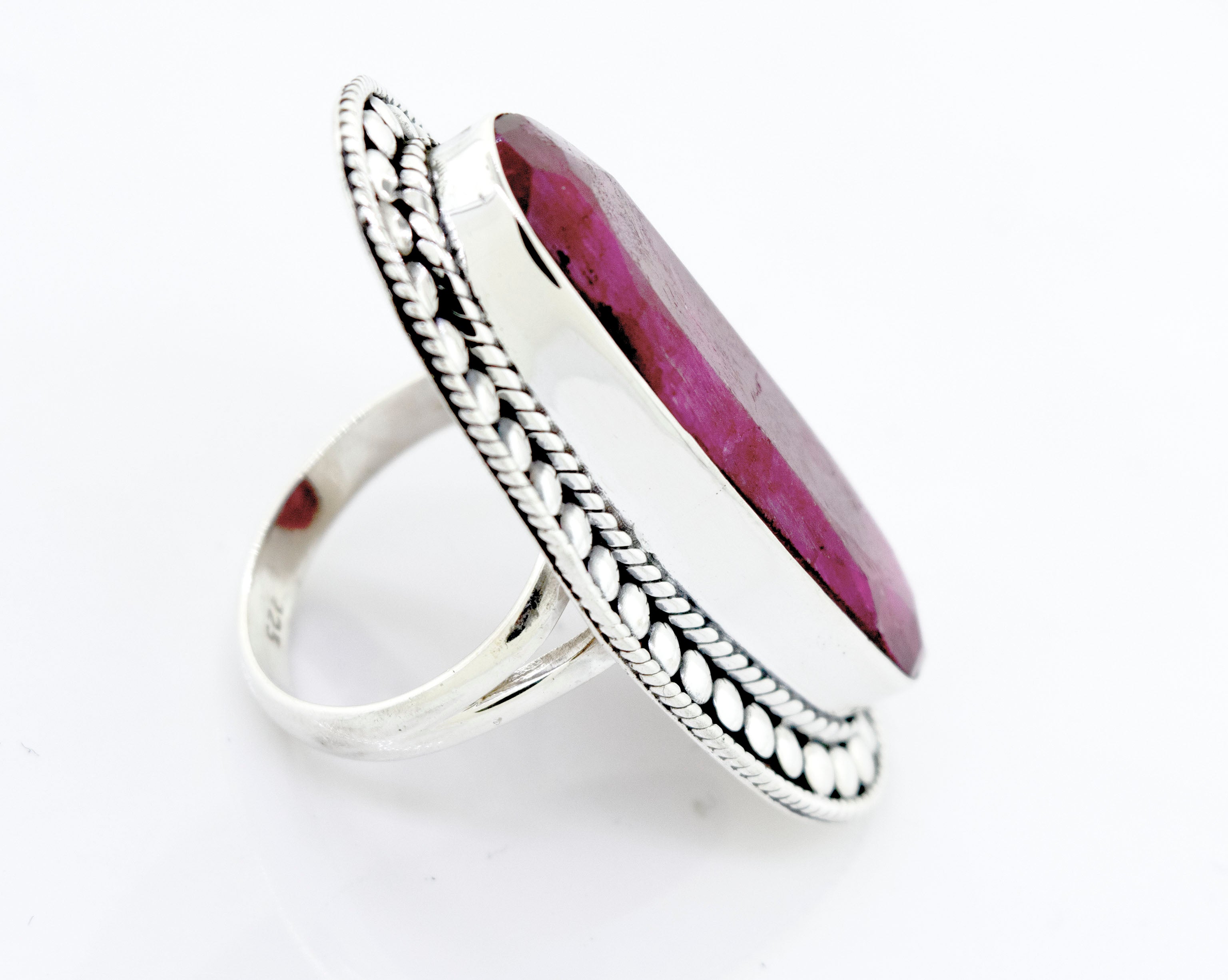 An Elegant Raw Ruby Ring with a ruby stone in the center, set in a Super Silver setting.